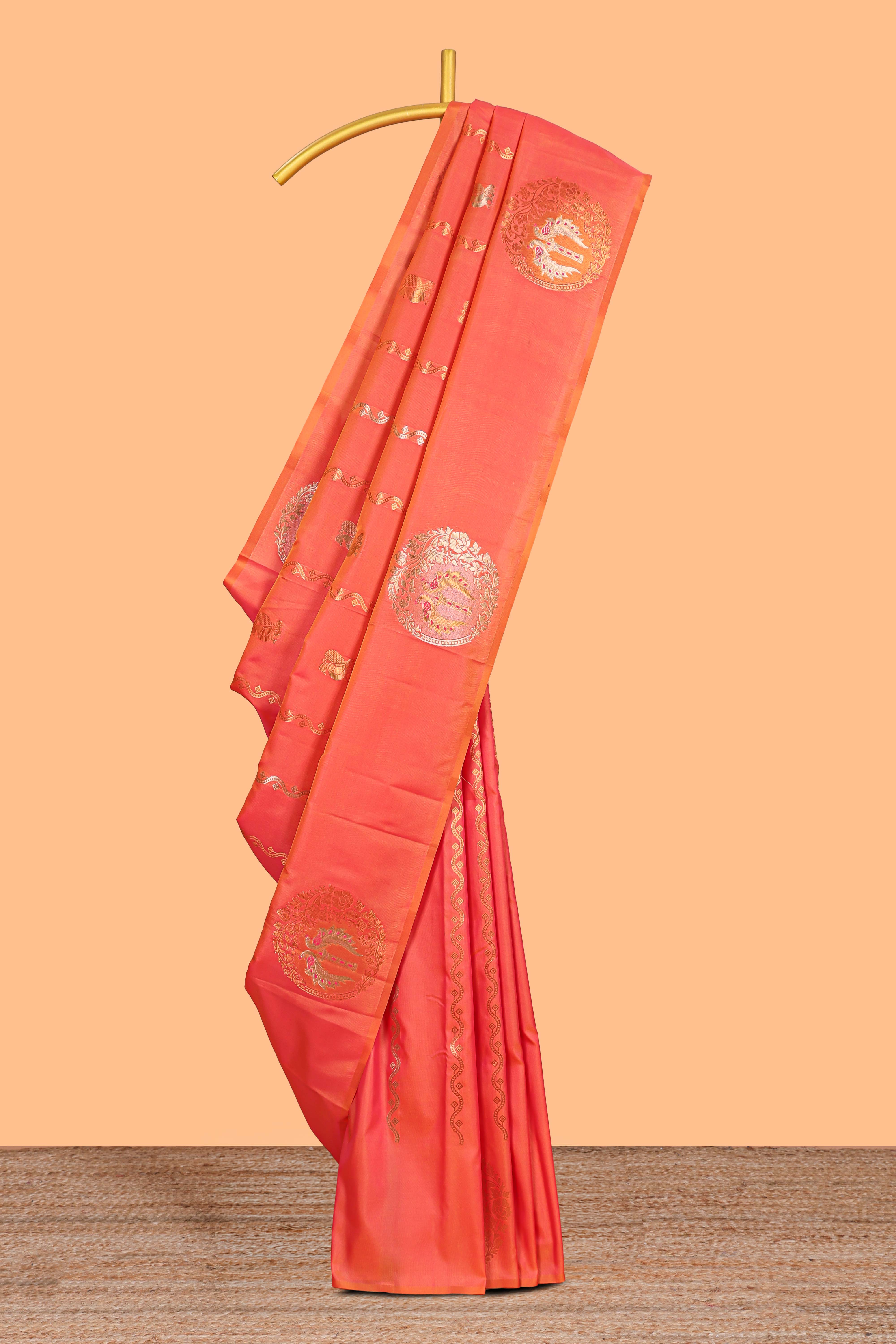 Orange colour Semi soft silk withgold zari floral motifs border with peacock motifs and matching blouse