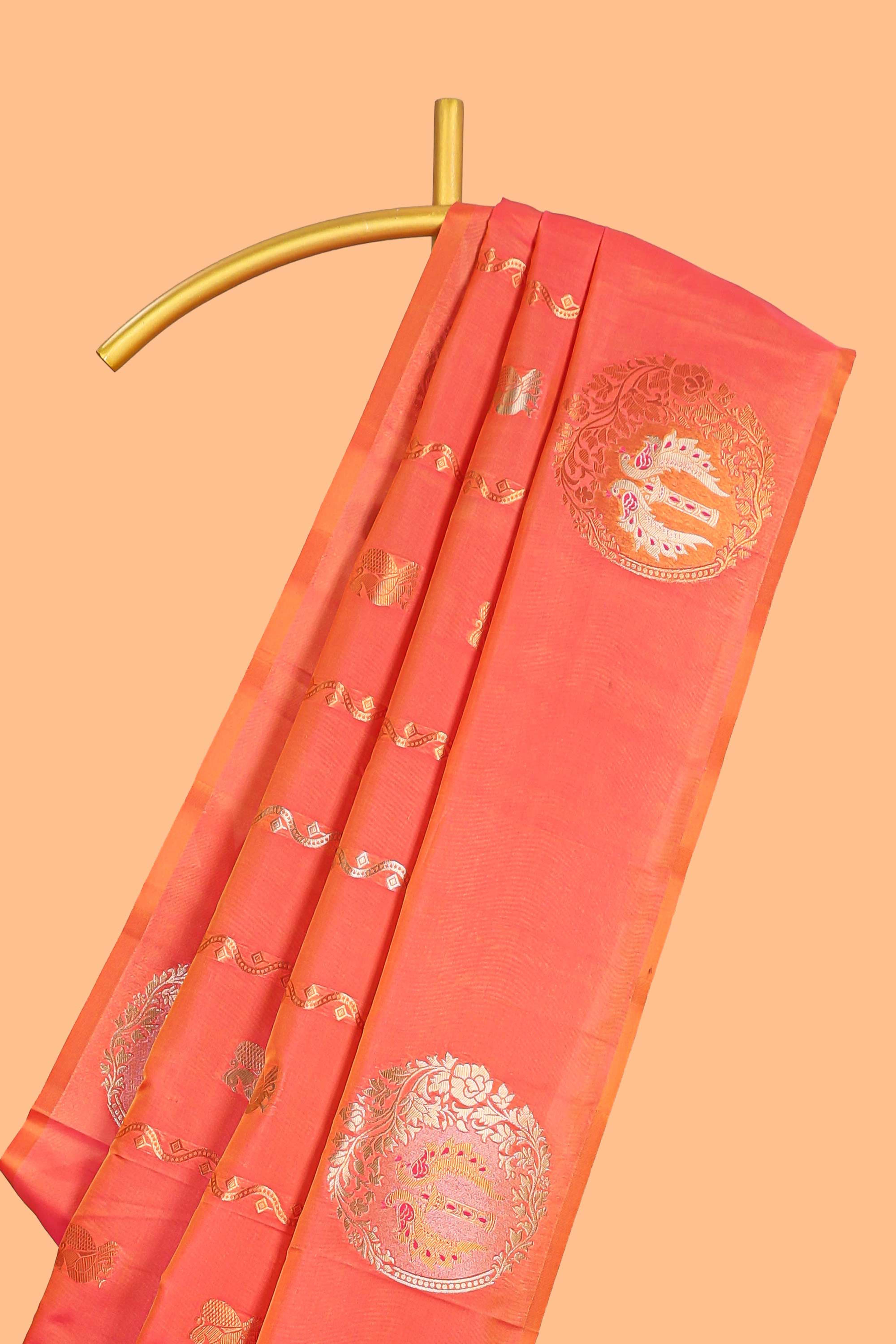 Orange colour Semi soft silk withgold zari floral motifs border with peacock motifs and matching blouse
