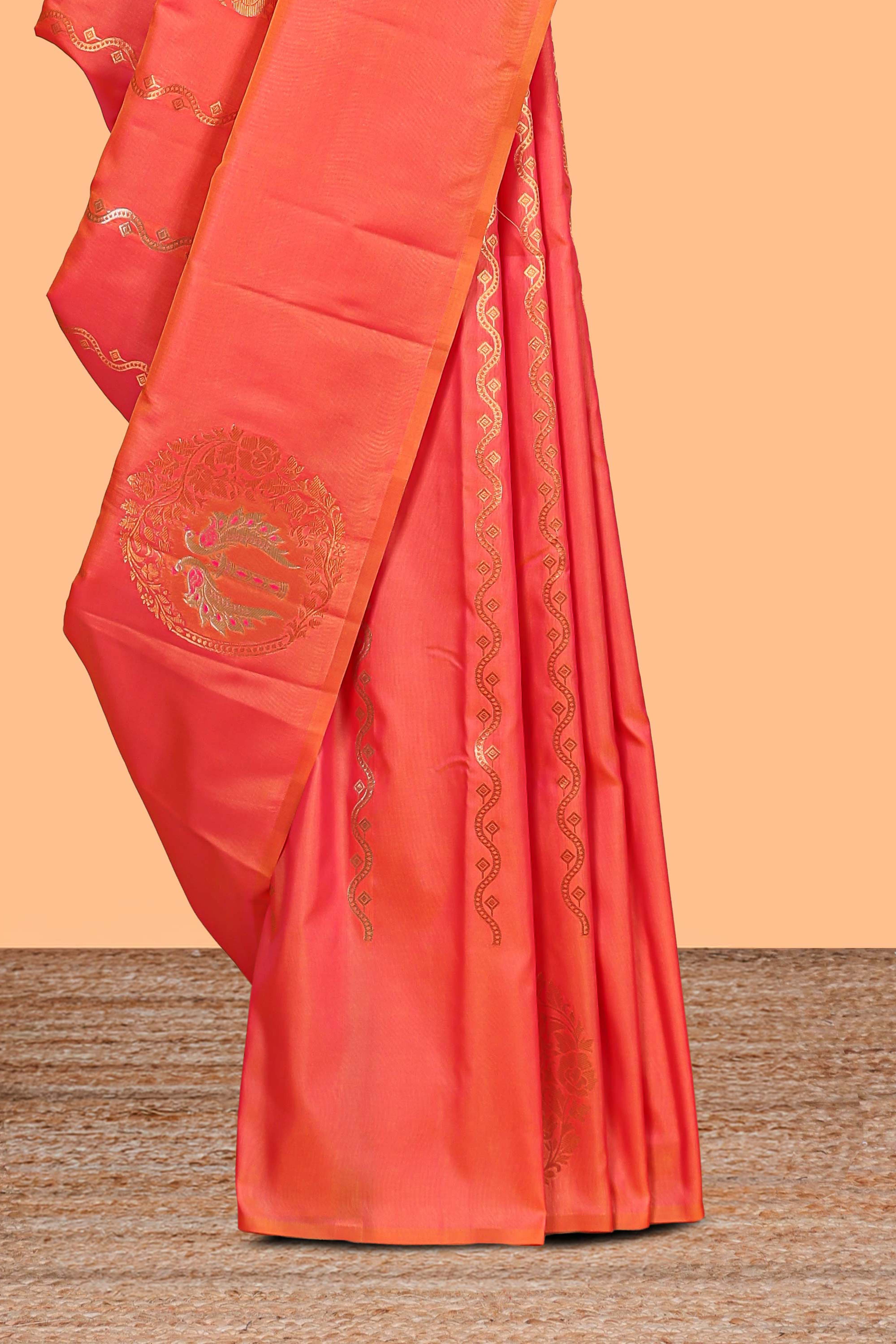 Orange colour Semi soft silk withgold zari floral motifs border with peacock motifs and matching blouse