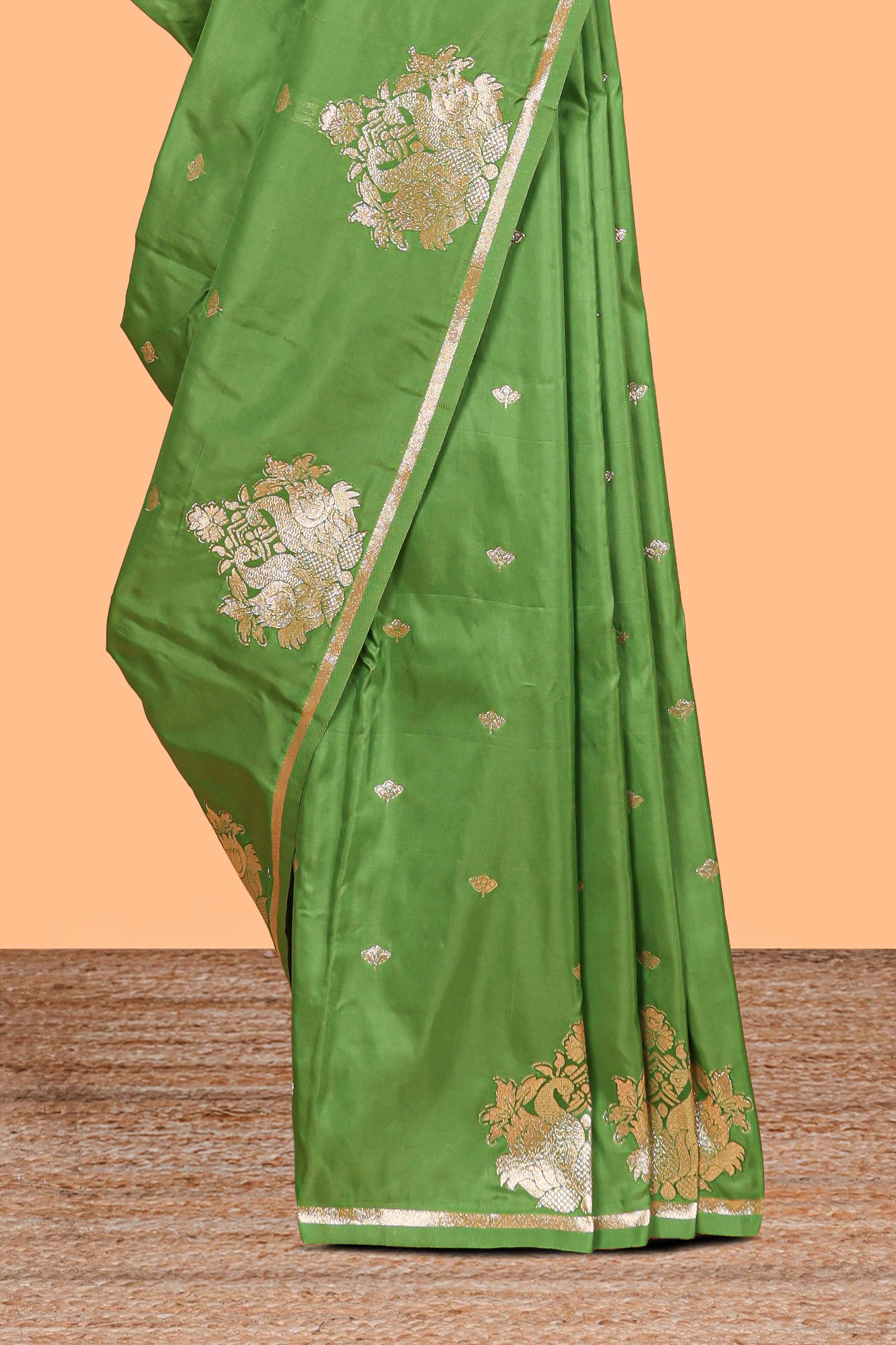 Green colour Semi soft silk withgold zari floral motifs border with peacock motifs and matching blouse