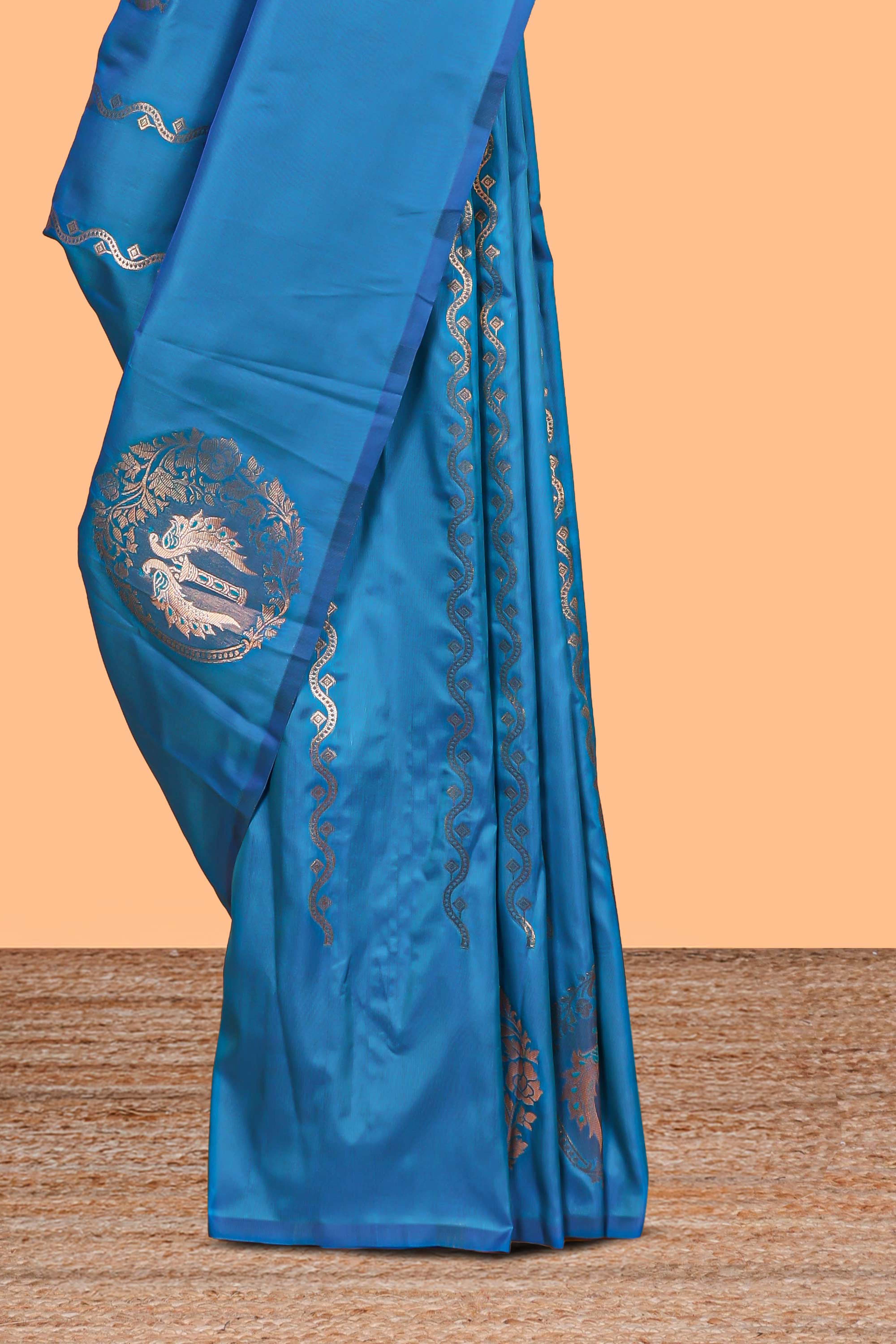 Blue colour Semi soft silk withgold zari floral motifs border with Vaira oosi Design and matching blouse