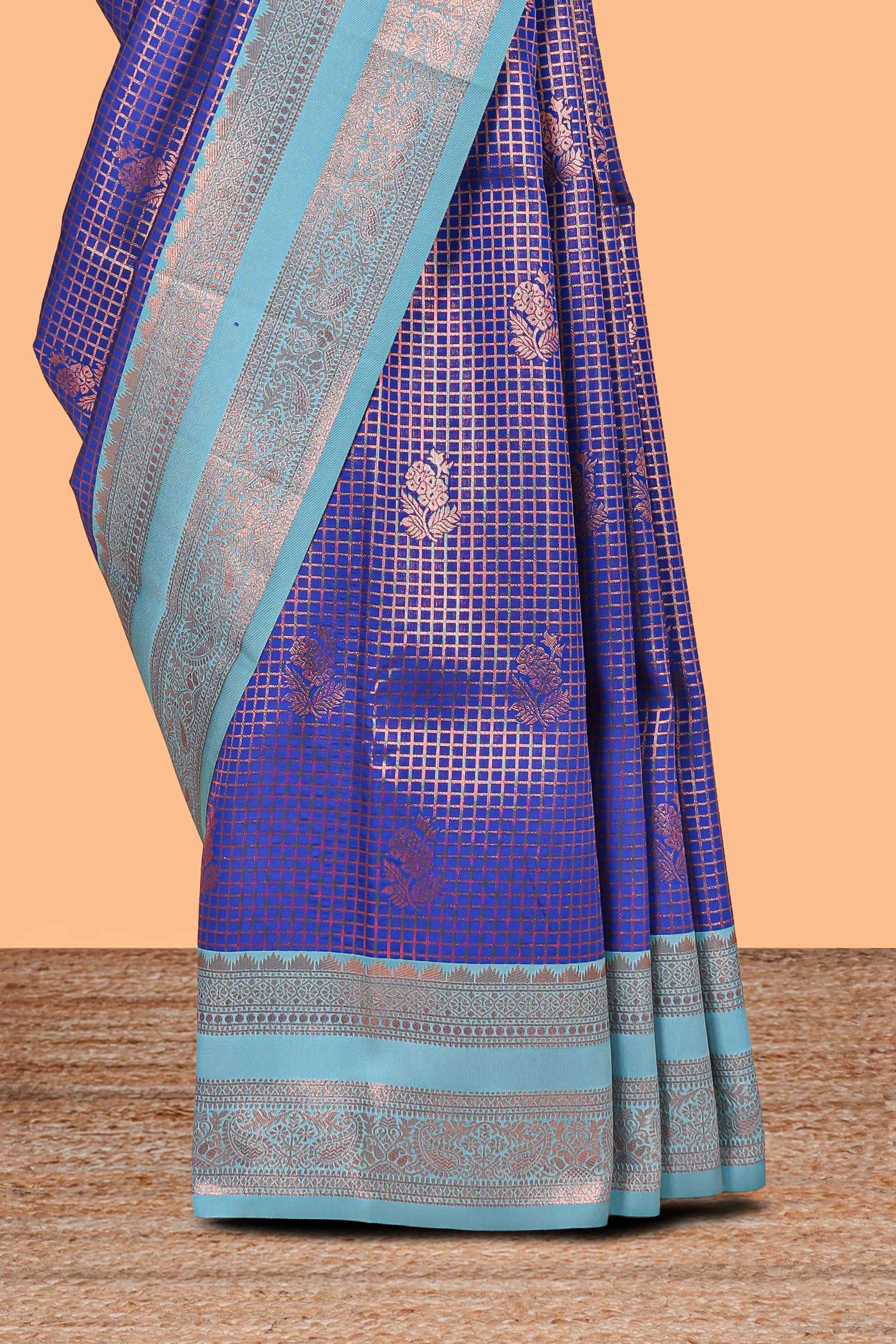 Blue checked floral motifs design semi soft silk saree with contrast zari border and floral motifs blouse
