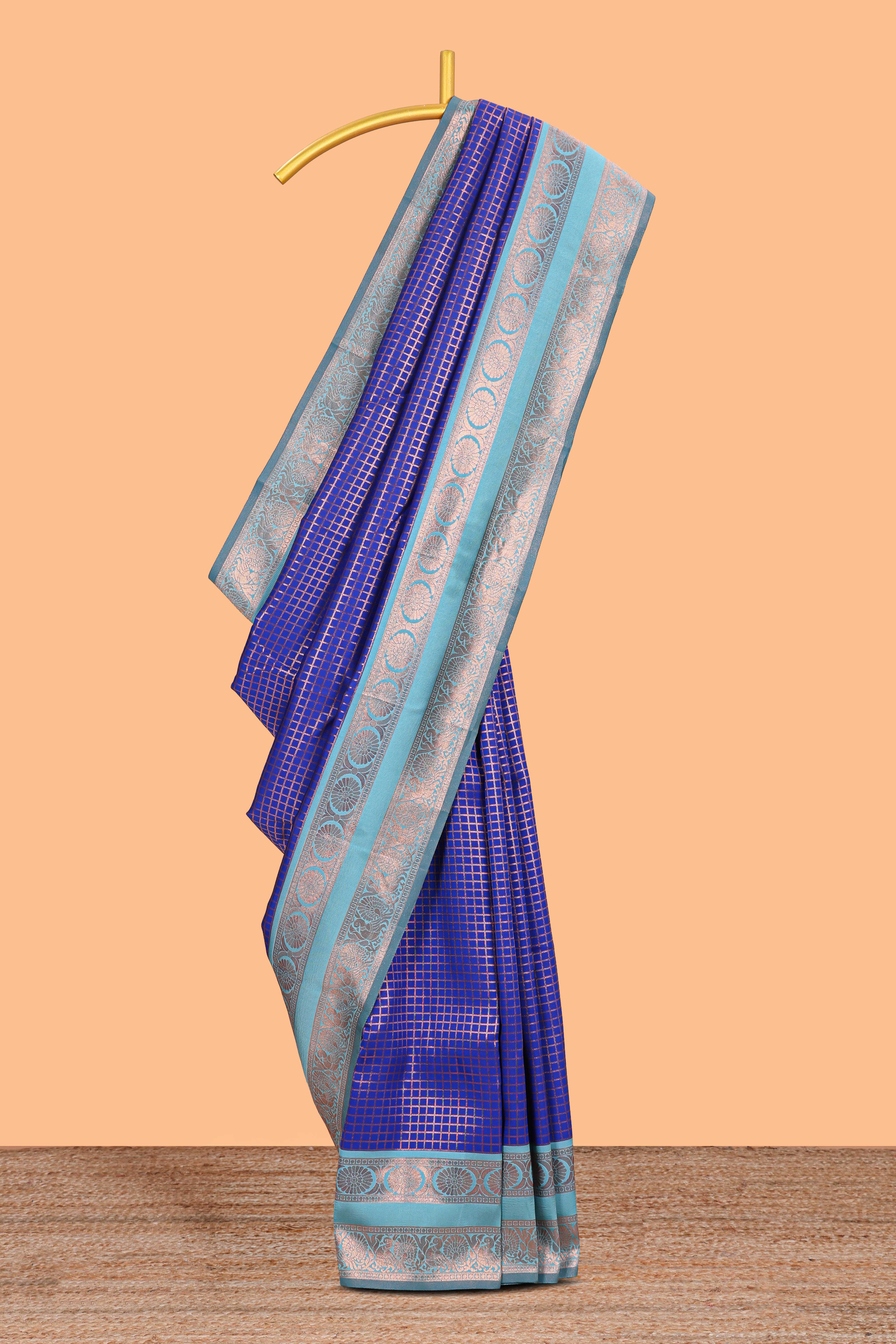 Blue checked semi soft silk saree with contrast zari border and floral motifs blouse