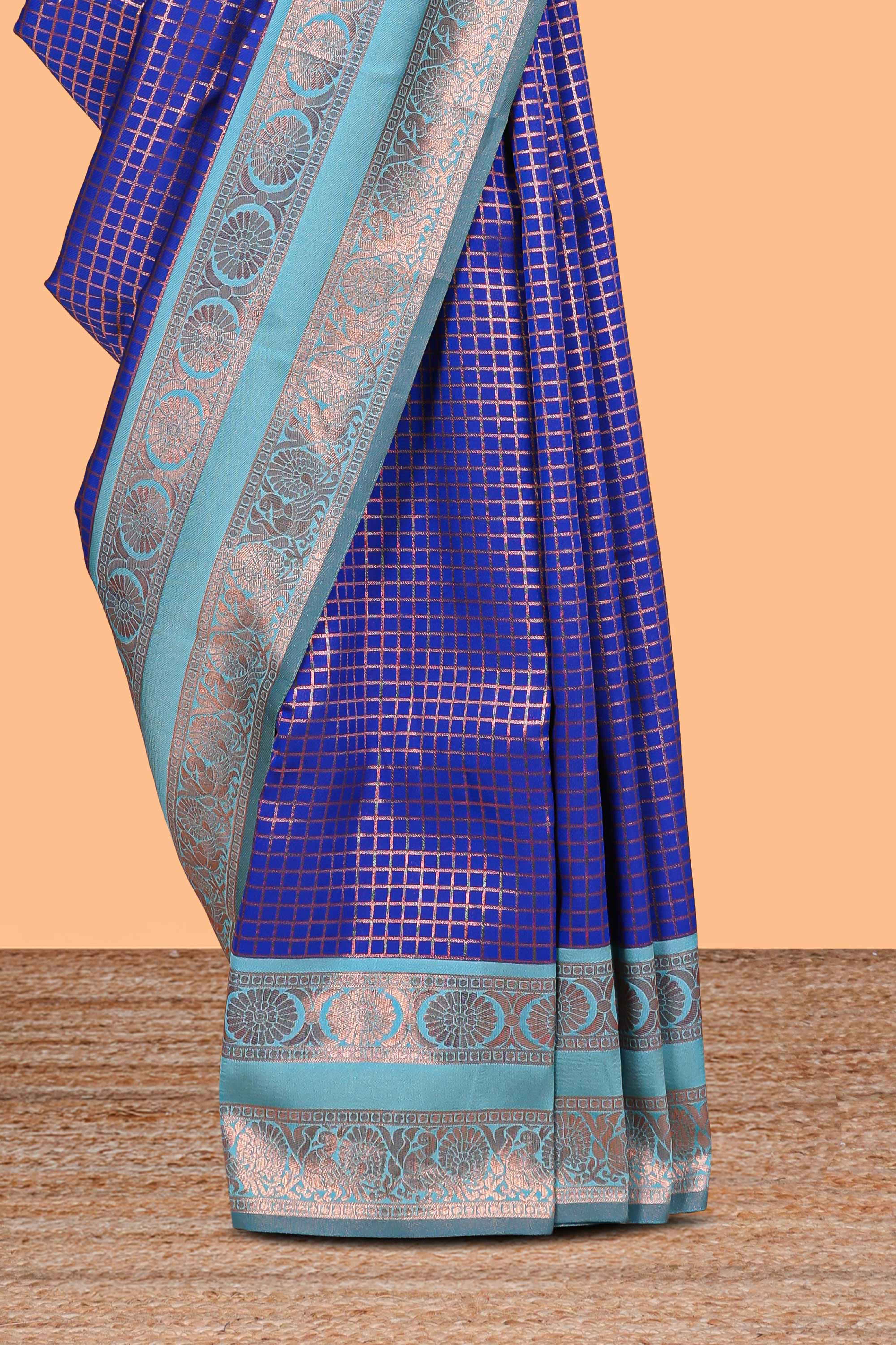 Blue checked semi soft silk saree with contrast zari border and floral motifs blouse