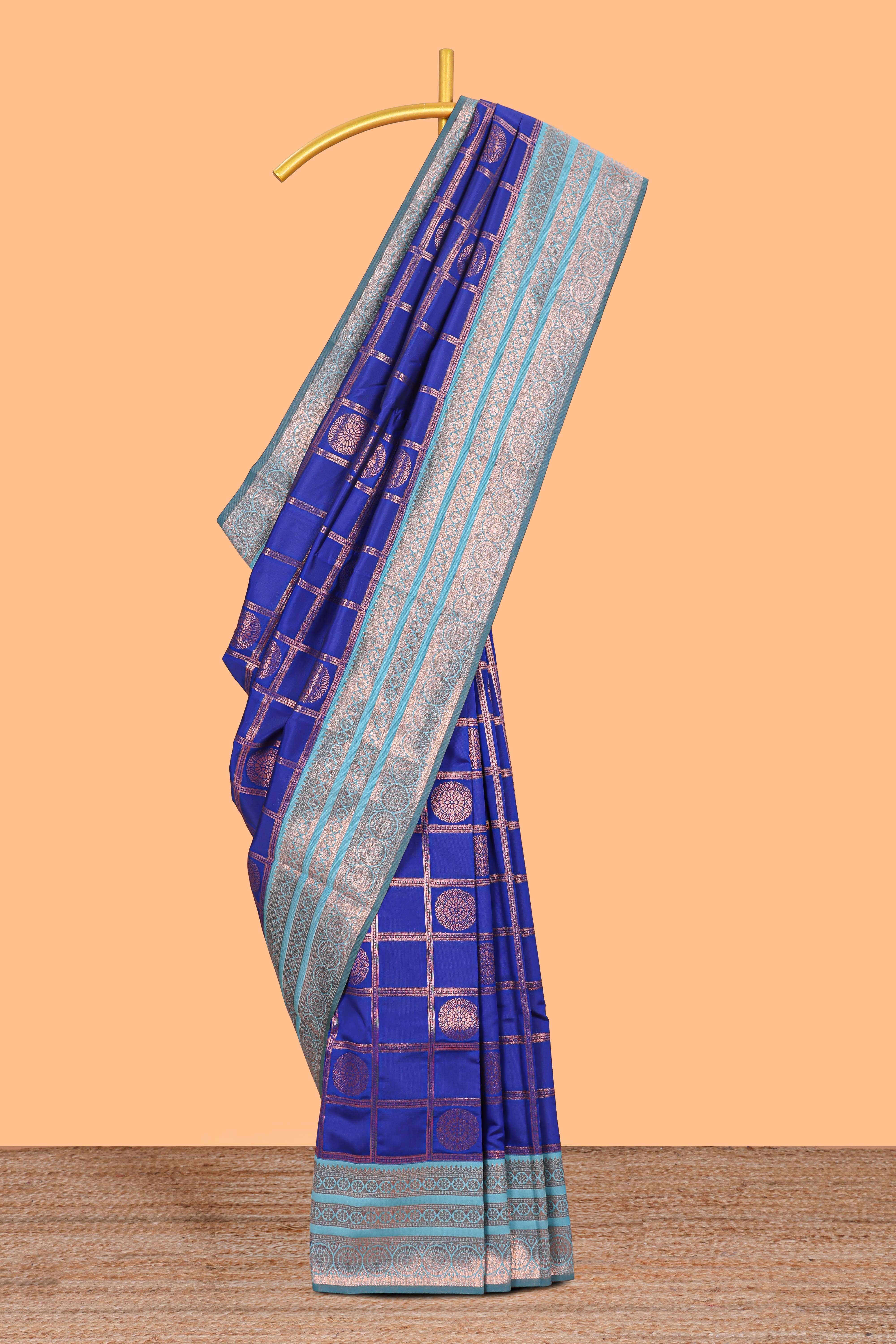 Blue checked floral design motifs semi soft silk saree with contrast zari border and floral motifs blouse