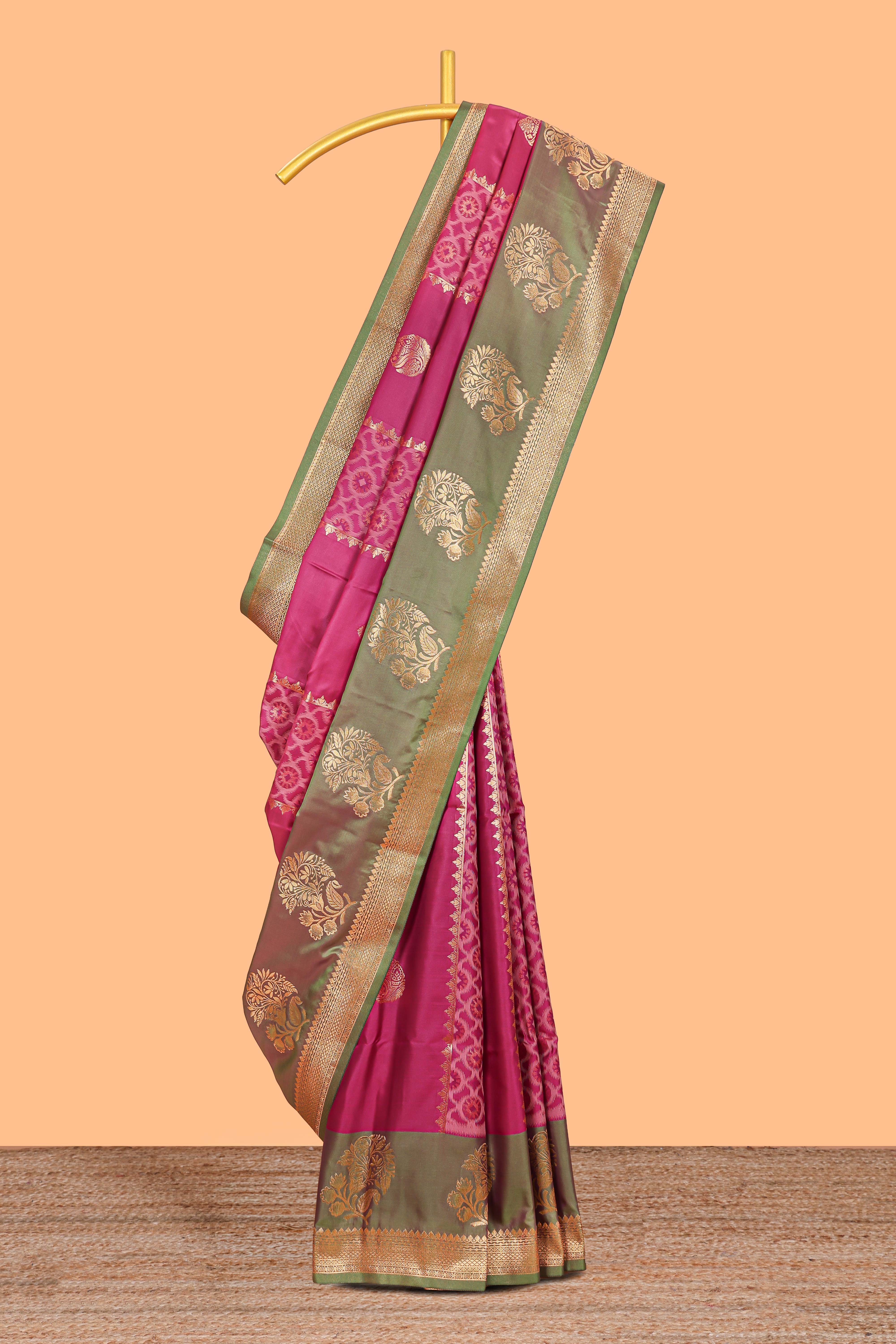 Magenta colour semi soft silk saree with contrast paisely border and contrast zari buttas blouse