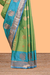 Green Semi soft silk sareecopperzari motifs with contrast border and pallu with a matchingblouse