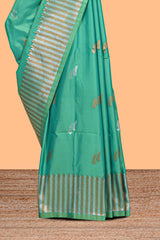 Green colour semi soft silk Woven Zari-Inspired Motifs and Geometric Weave Design border with contrast pallu and blouse