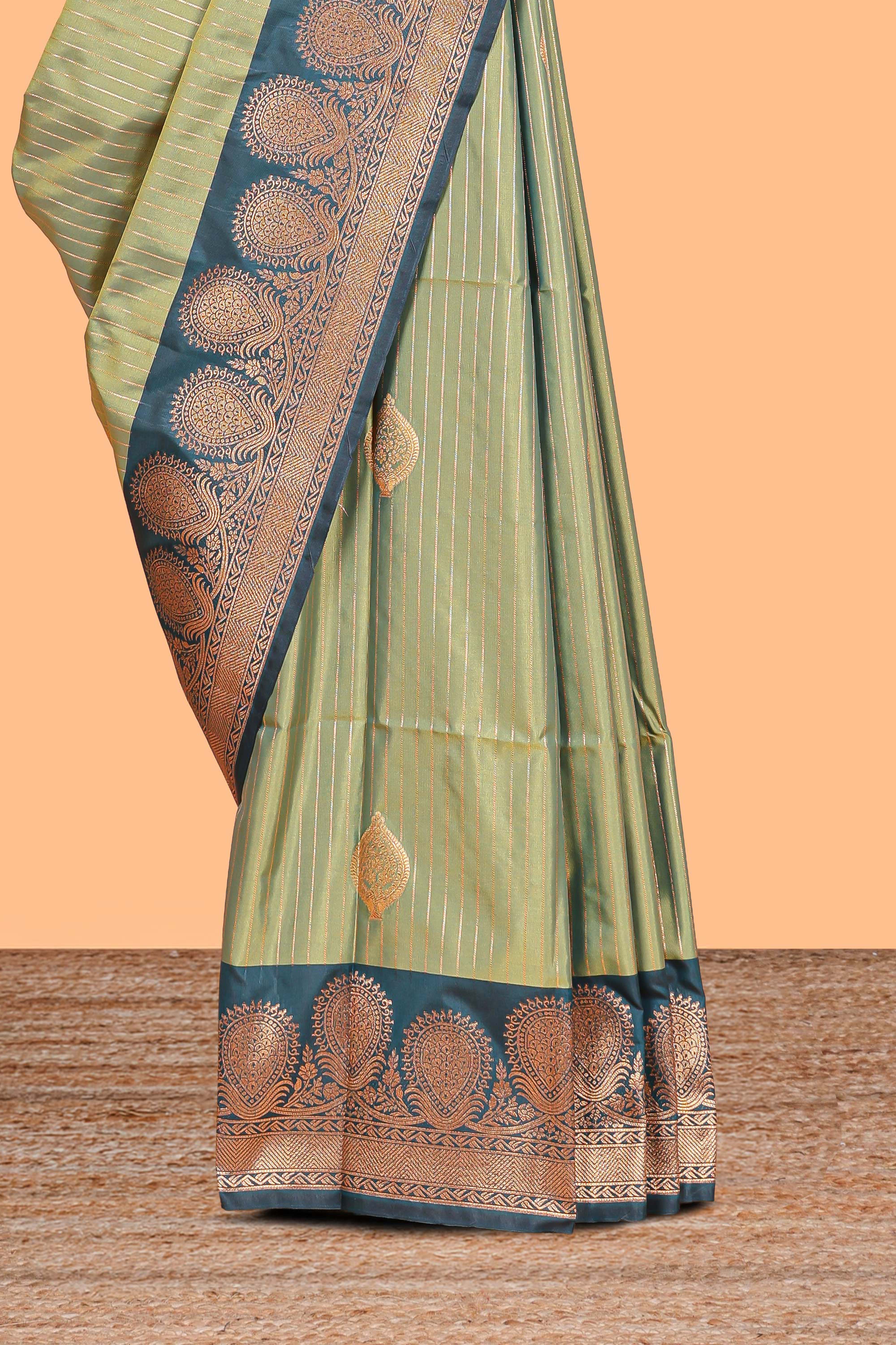 Green colour semi soft silk all over zari striped pattern with contrast zari weaving border and contrast buttas weaving blouse