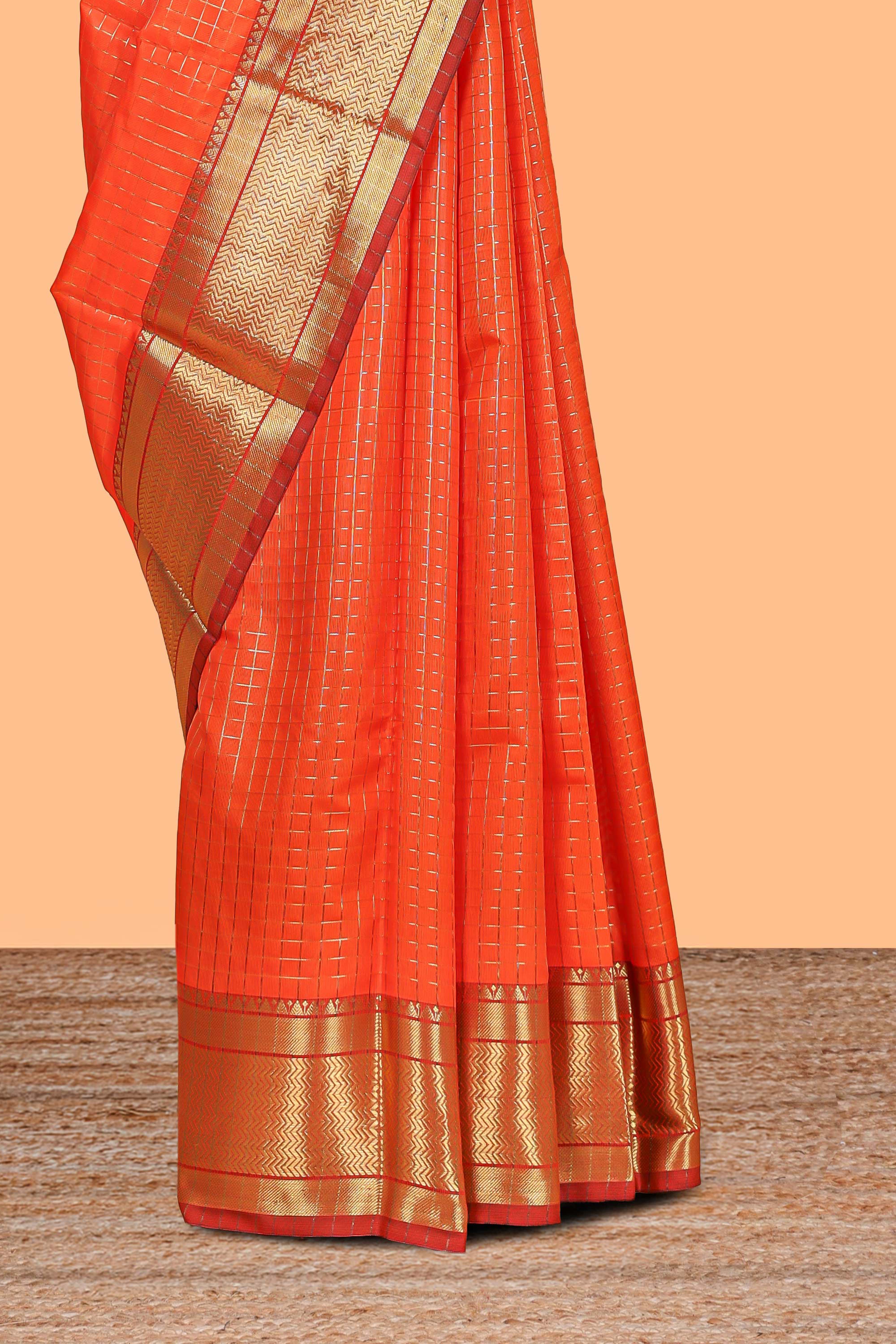 Orange colour semi soft silk all over checked pattern andContrast zari weaving border and contrastblouse