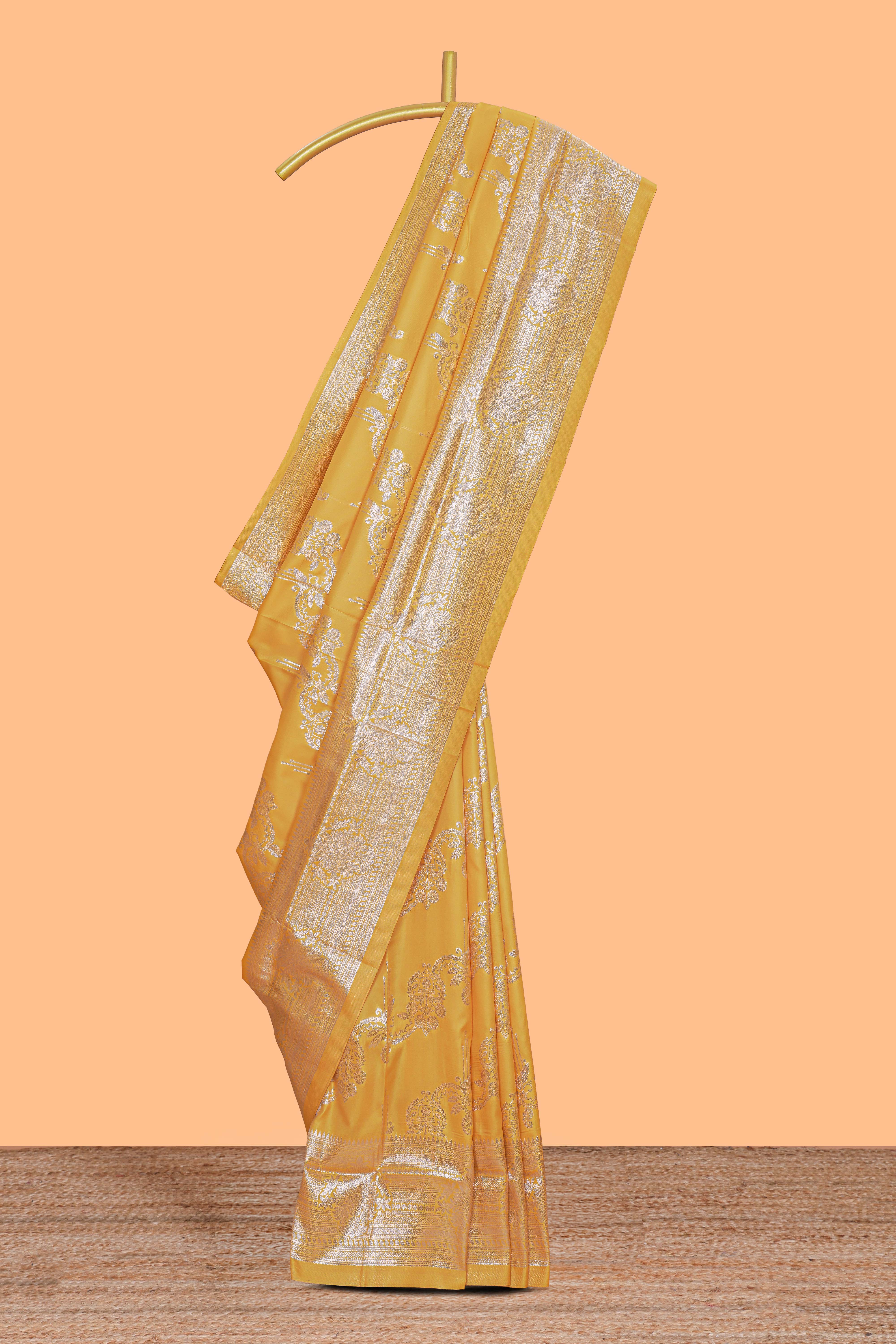 Yellow zari design semi soft silk saree with self zari border and matching blouse