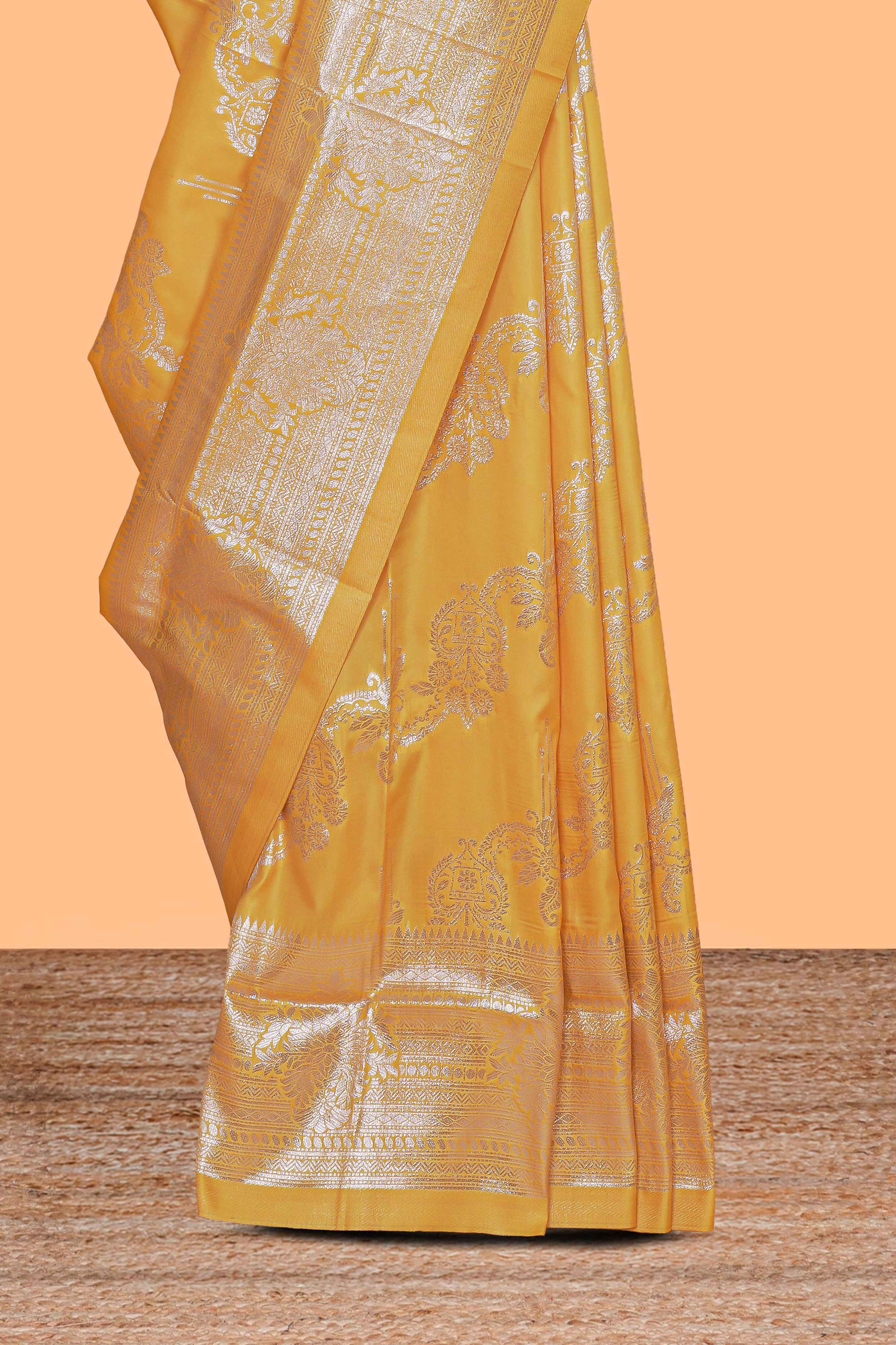 Yellow zari design semi soft silk saree with self zari border and matching blouse