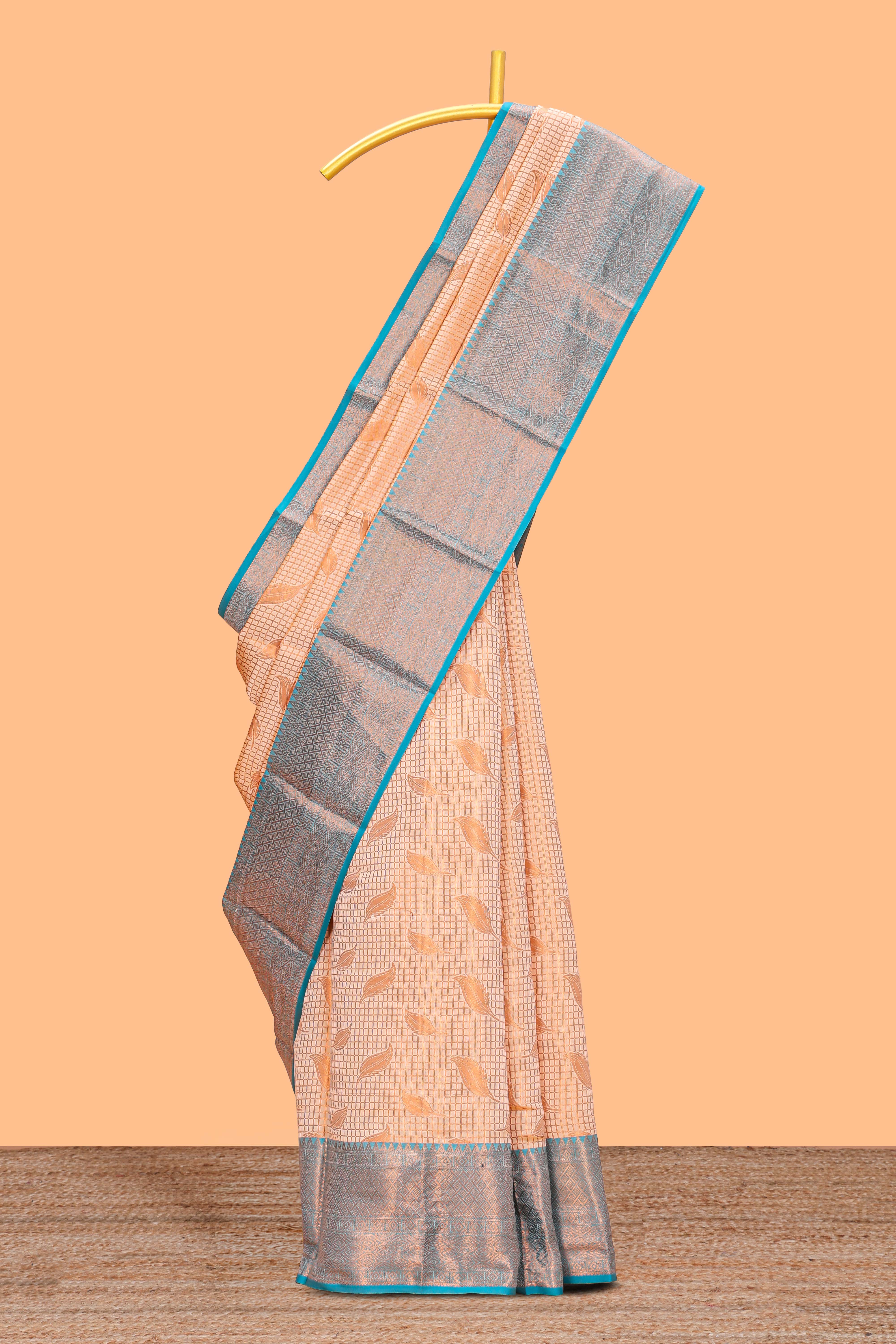 Peach checked leaf zari motifs design semi soft silk saree with contrast zari border and blouse