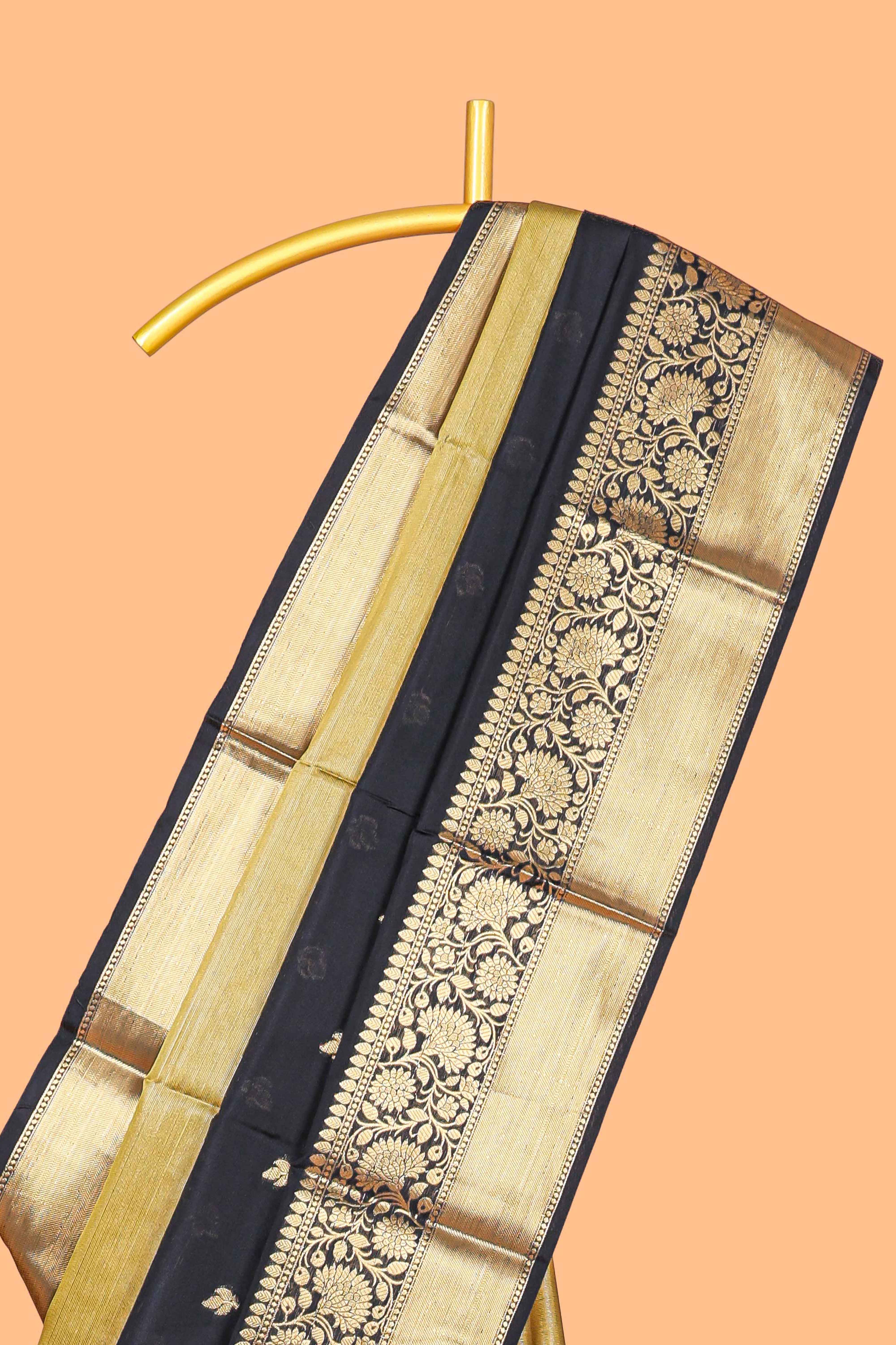 Black floral butta detailed Semi Soft Silk Saree with rich gold floral zari borders along with matching blouse