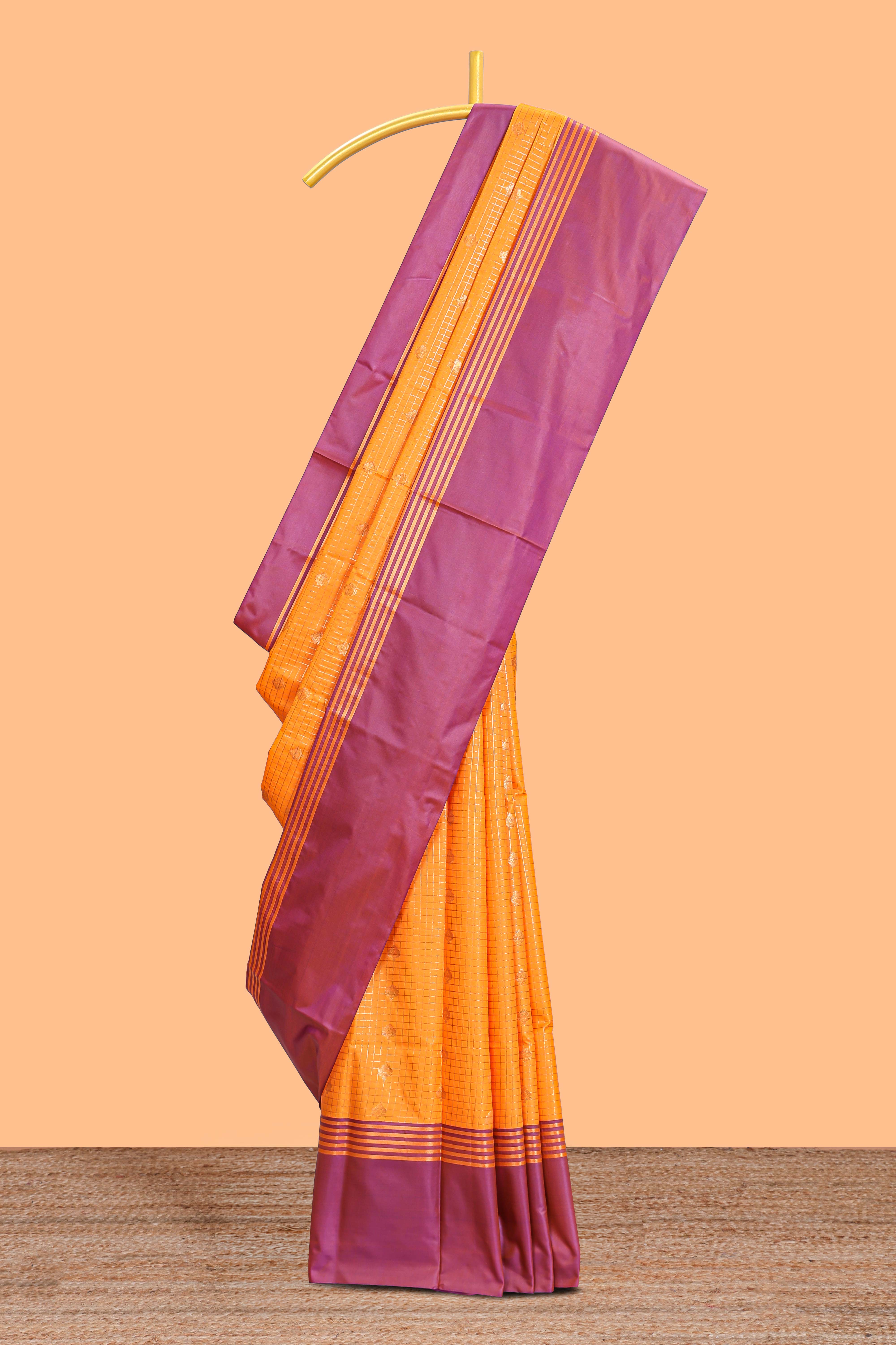 Orange checked floral design motifs semi soft silk saree with contrast border and blouse