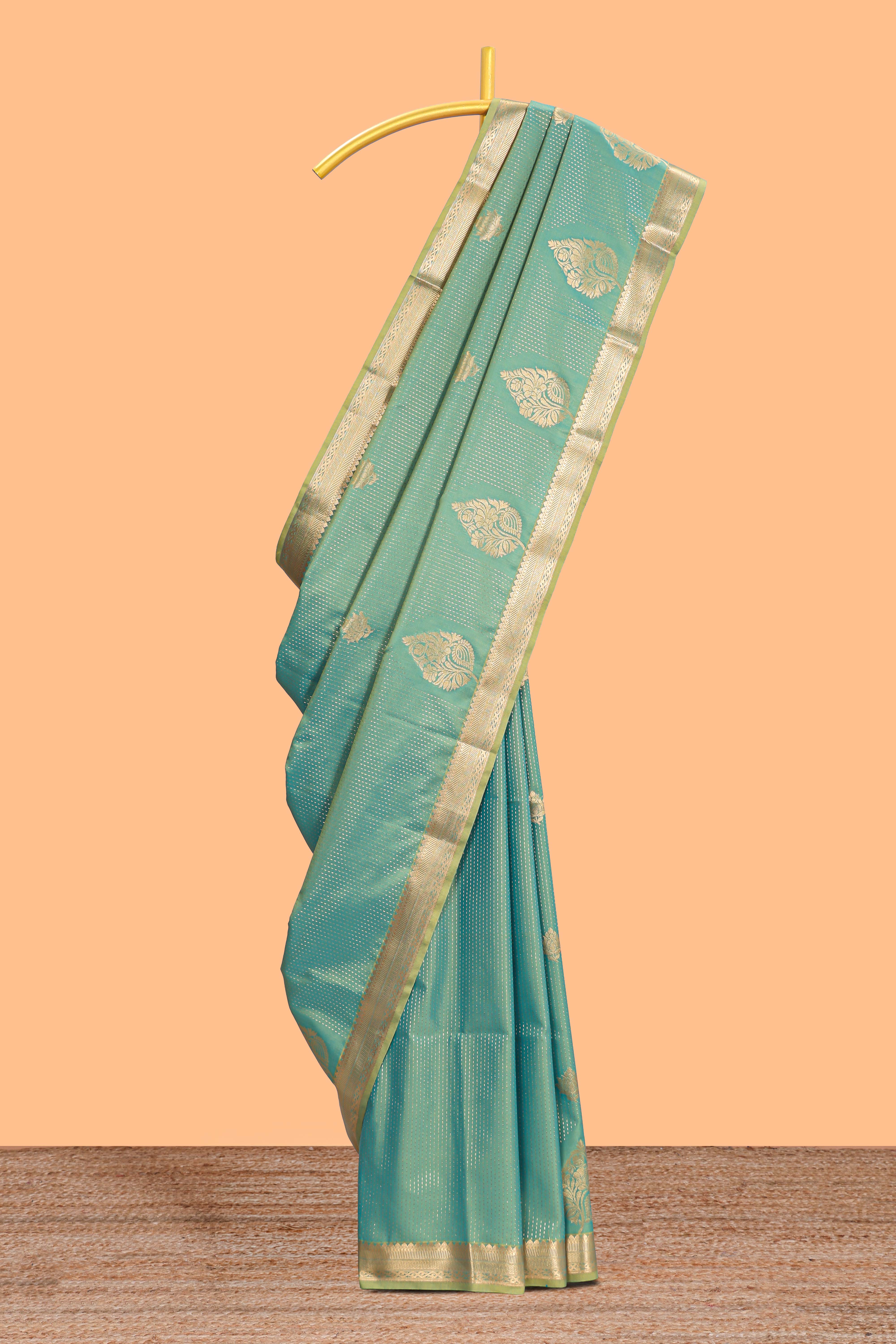 Green floral design motifs semi soft silk saree with self border and contrast blouse