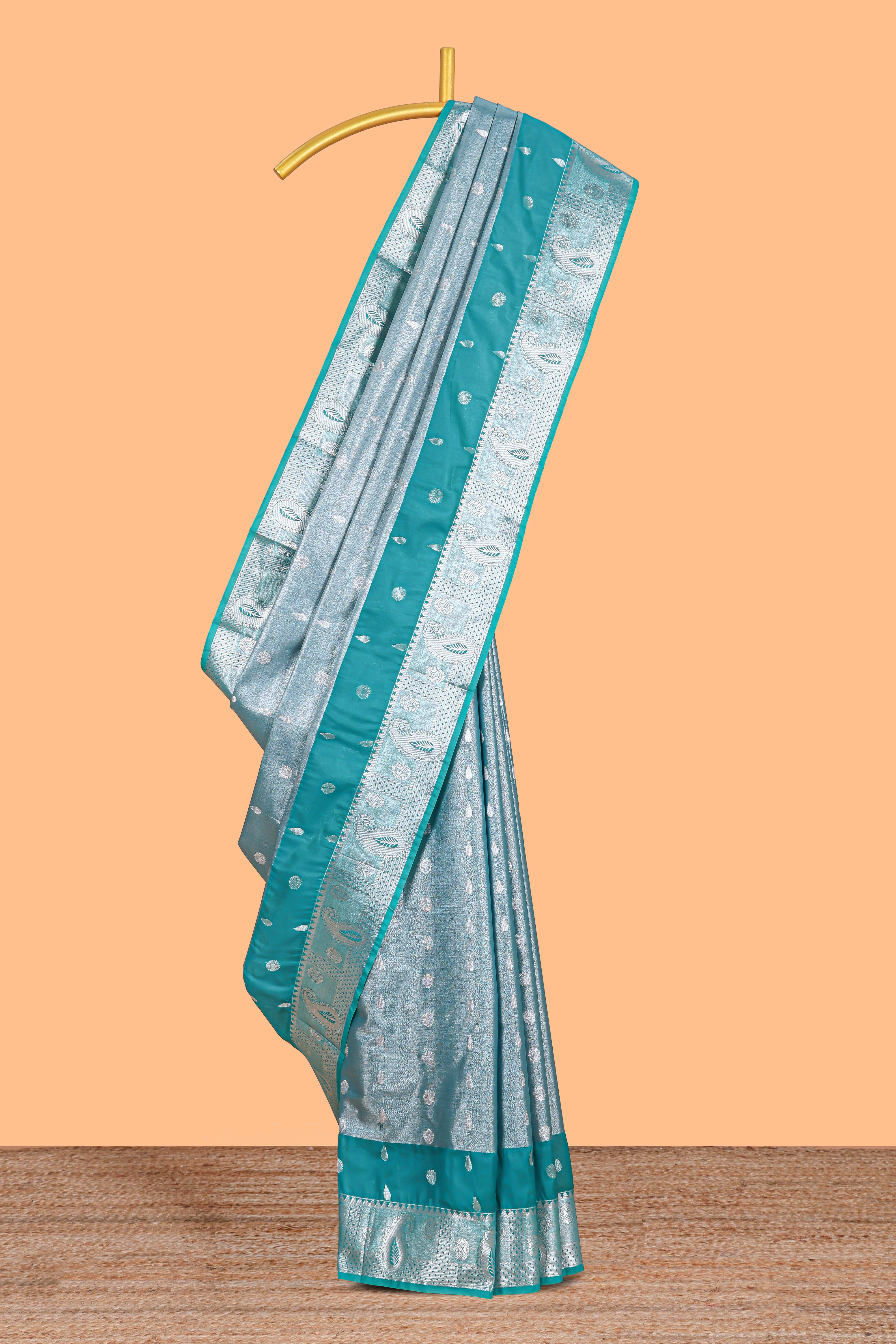 Peacock Teal Blue Tissue Silk Saree with Silver Zari Weaving and Contrast Teal Border along with Matching Blouse