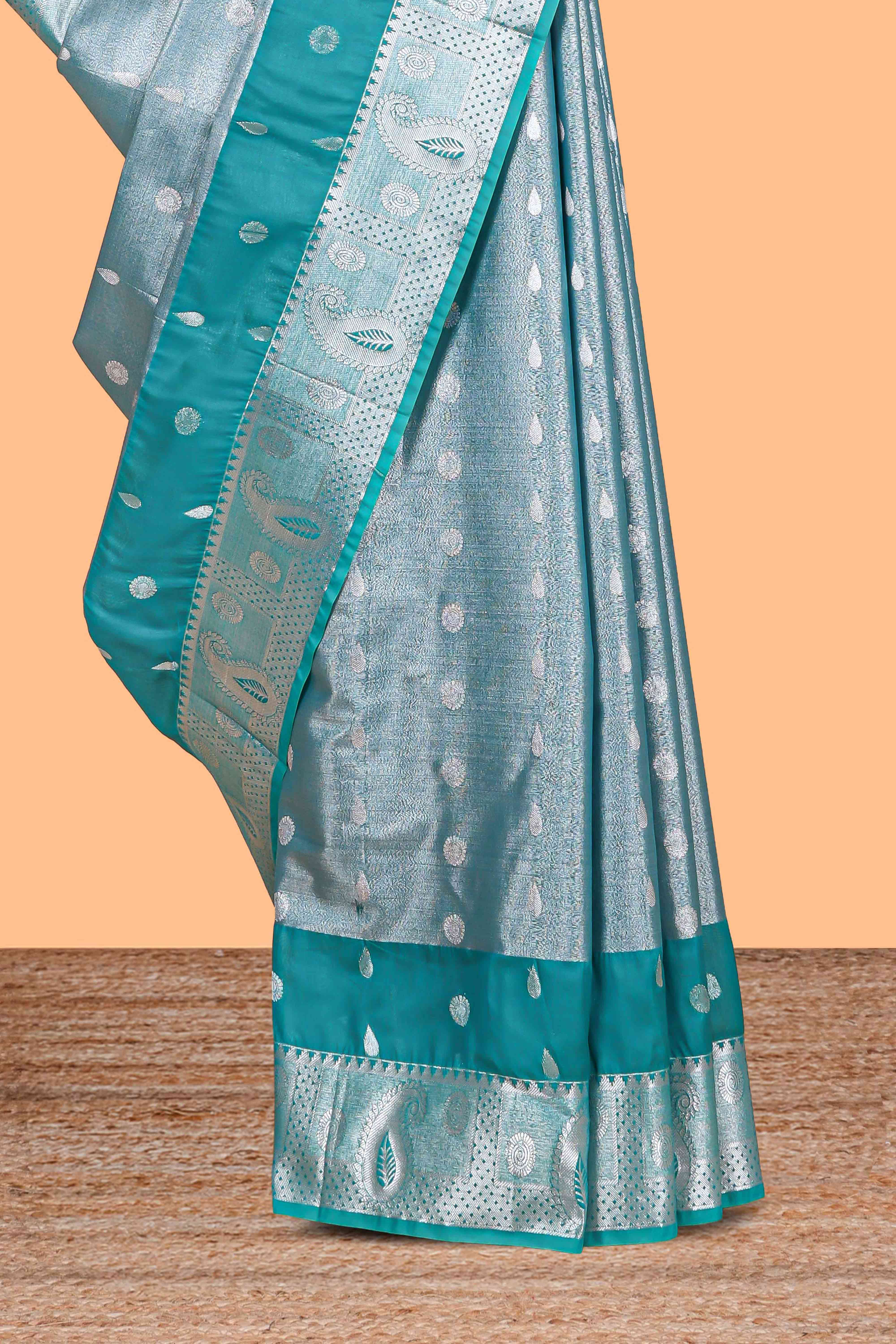 Peacock Teal Blue Tissue Silk Saree with Silver Zari Weaving and Contrast Teal Border along with Matching Blouse