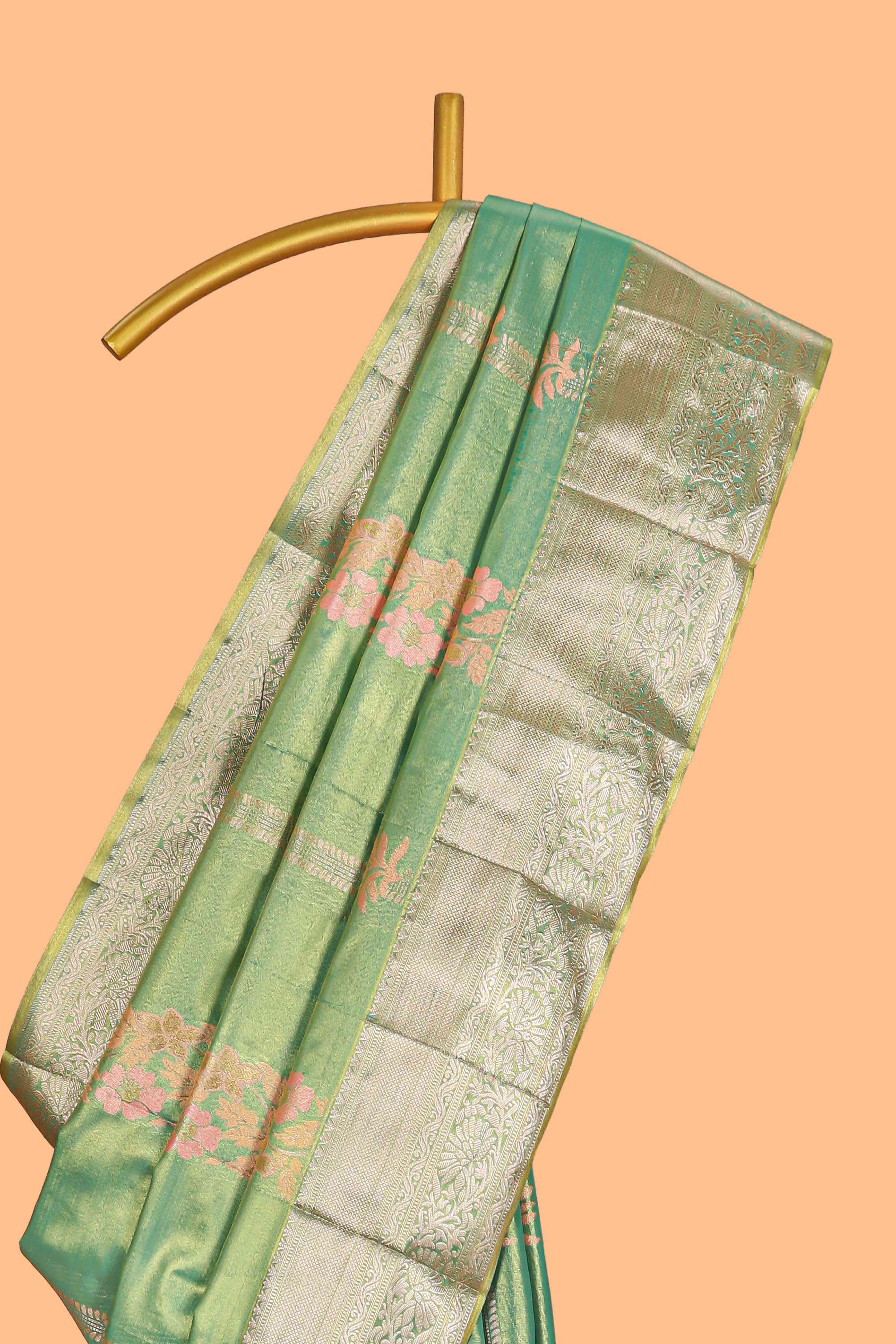 Pastel Green Tissue Silk Saree with Zari Weaving and PastelFloral Accents along with Matching Blouse
