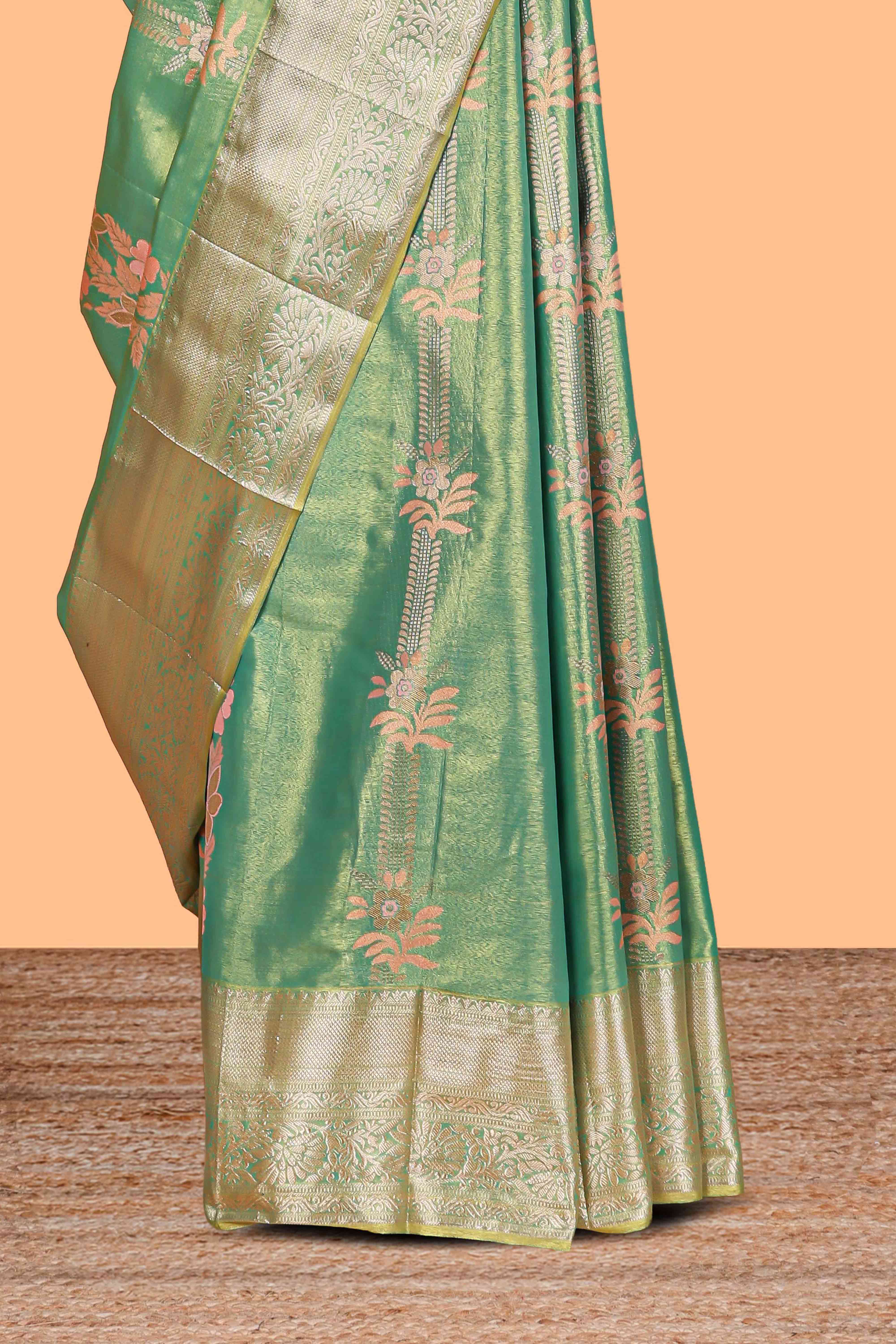 Pastel Green Tissue Silk Saree with Zari Weaving and PastelFloral Accents along with Matching Blouse