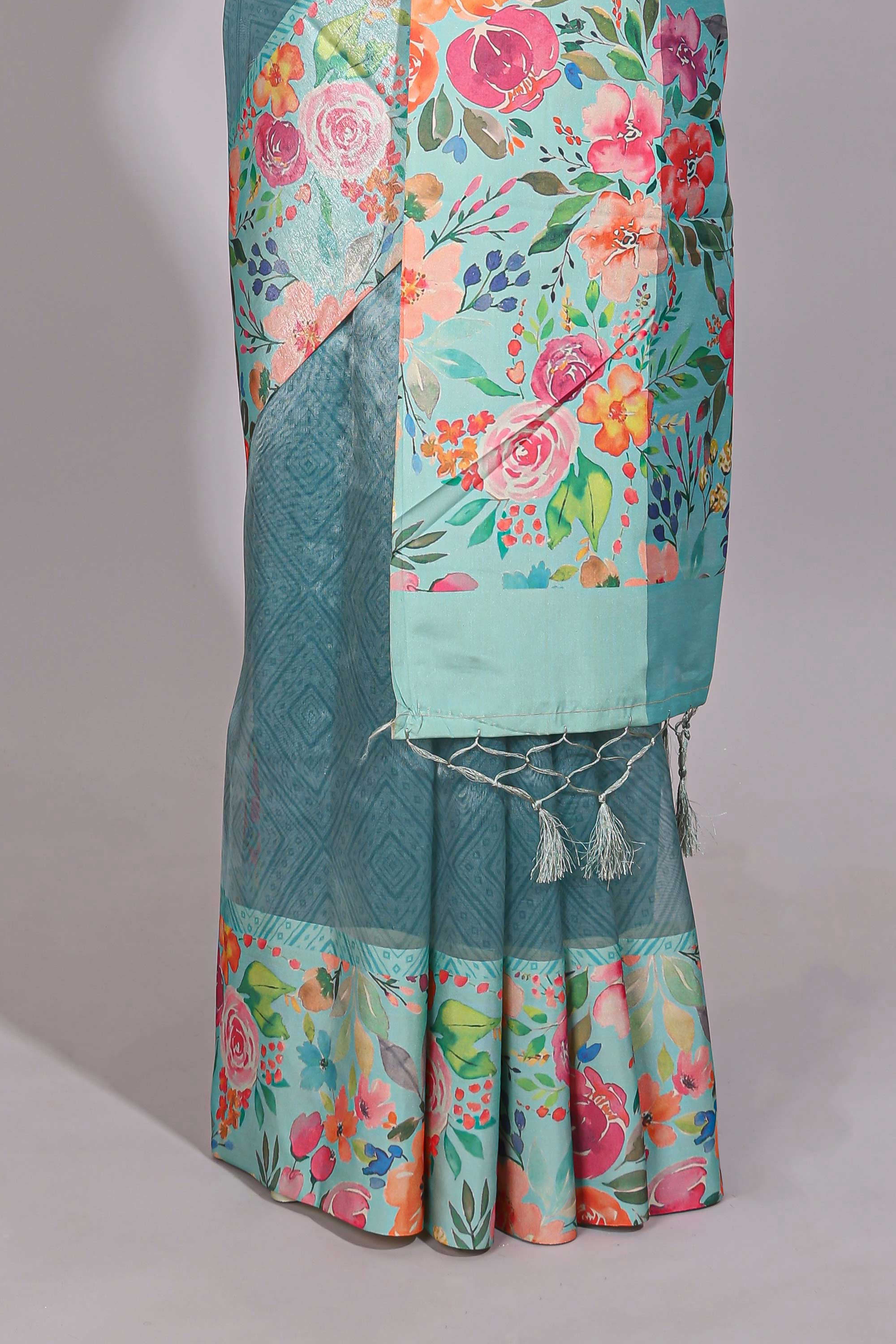 Blue geometric design tissue saree with contrast floral print border and printed blouse