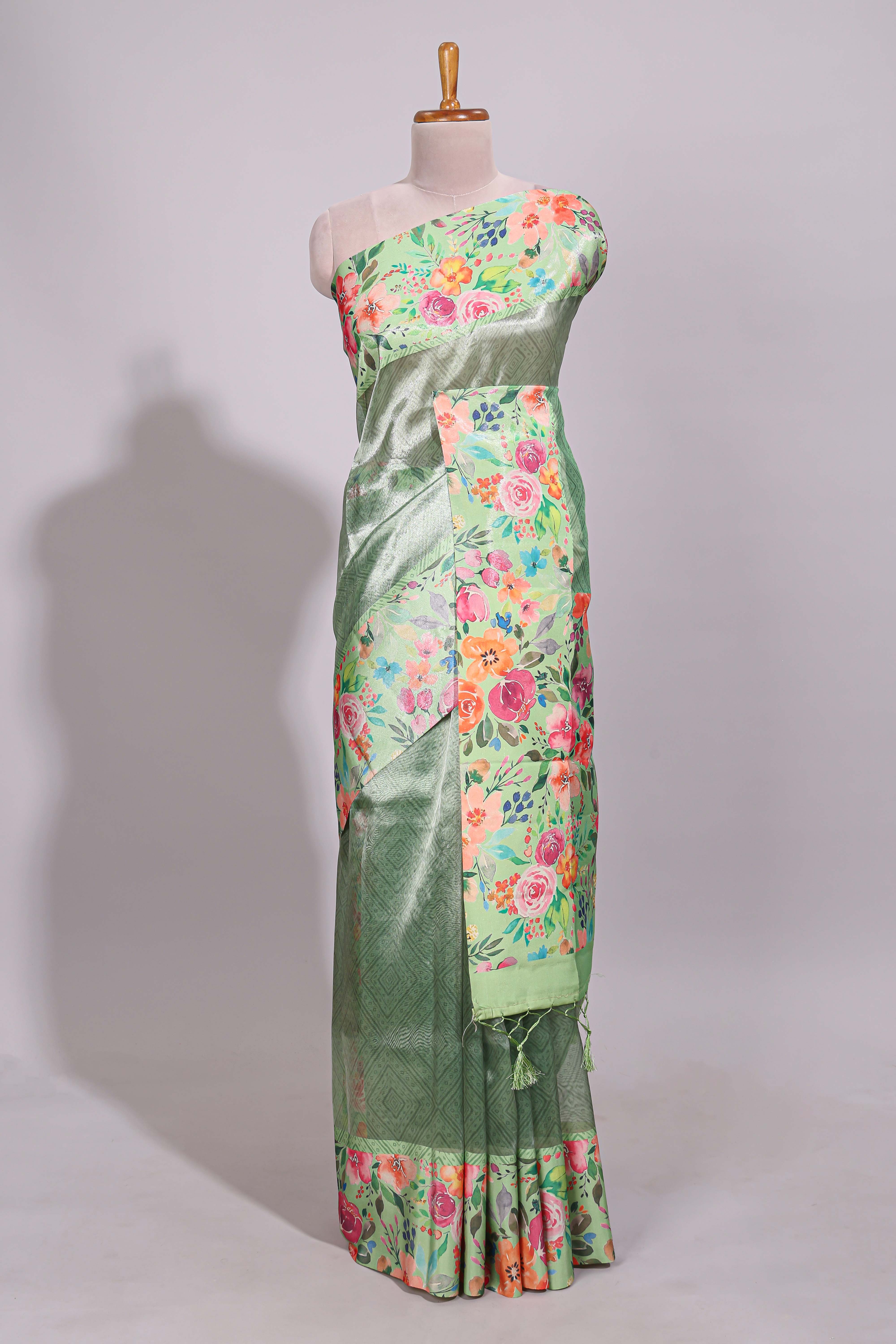 Green geometric design tissue saree with contrast floral print border and printed blouse