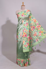 Green geometric design tissue saree with contrast floral print border and printed blouse