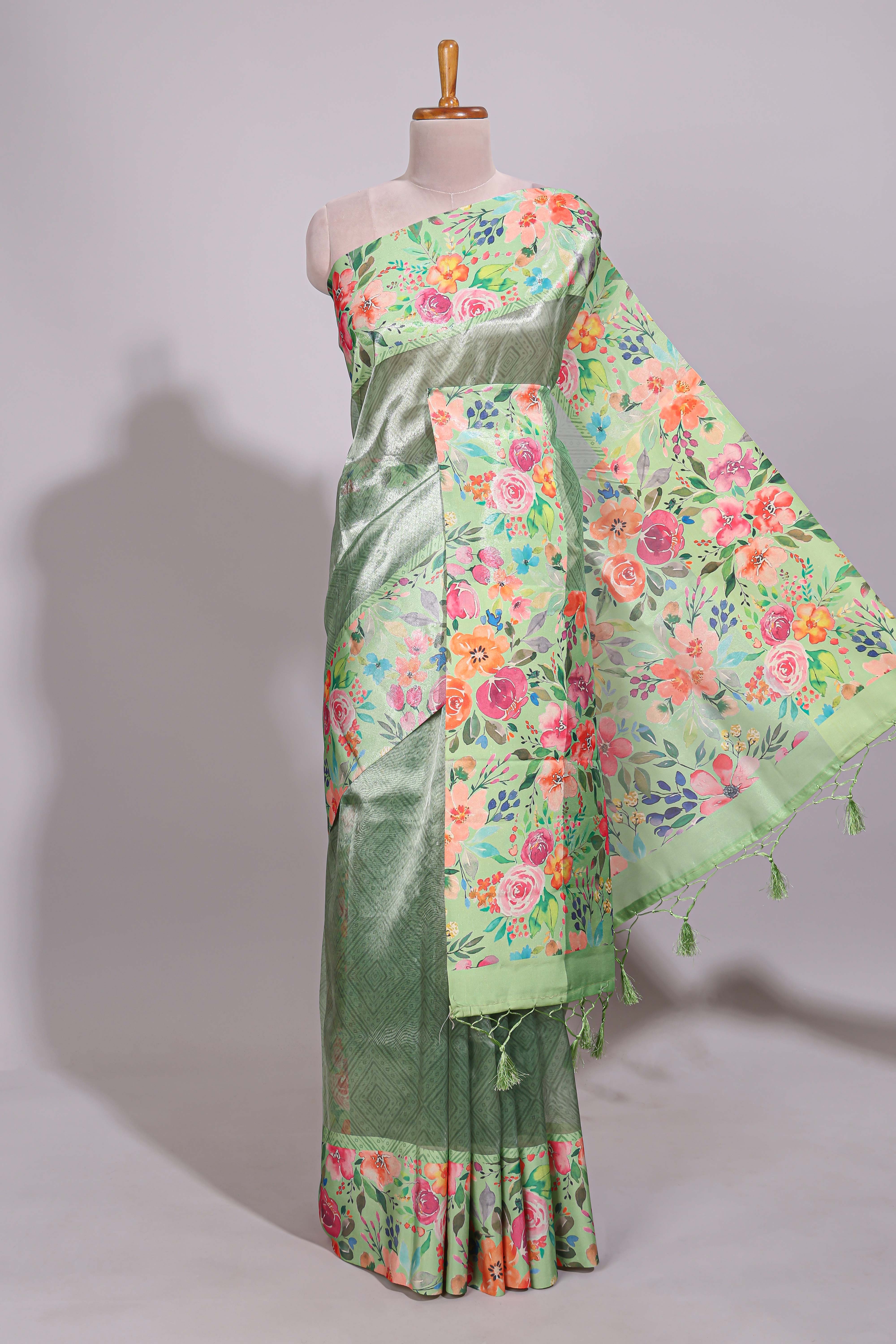 Green geometric design tissue saree with contrast floral print border and printed blouse