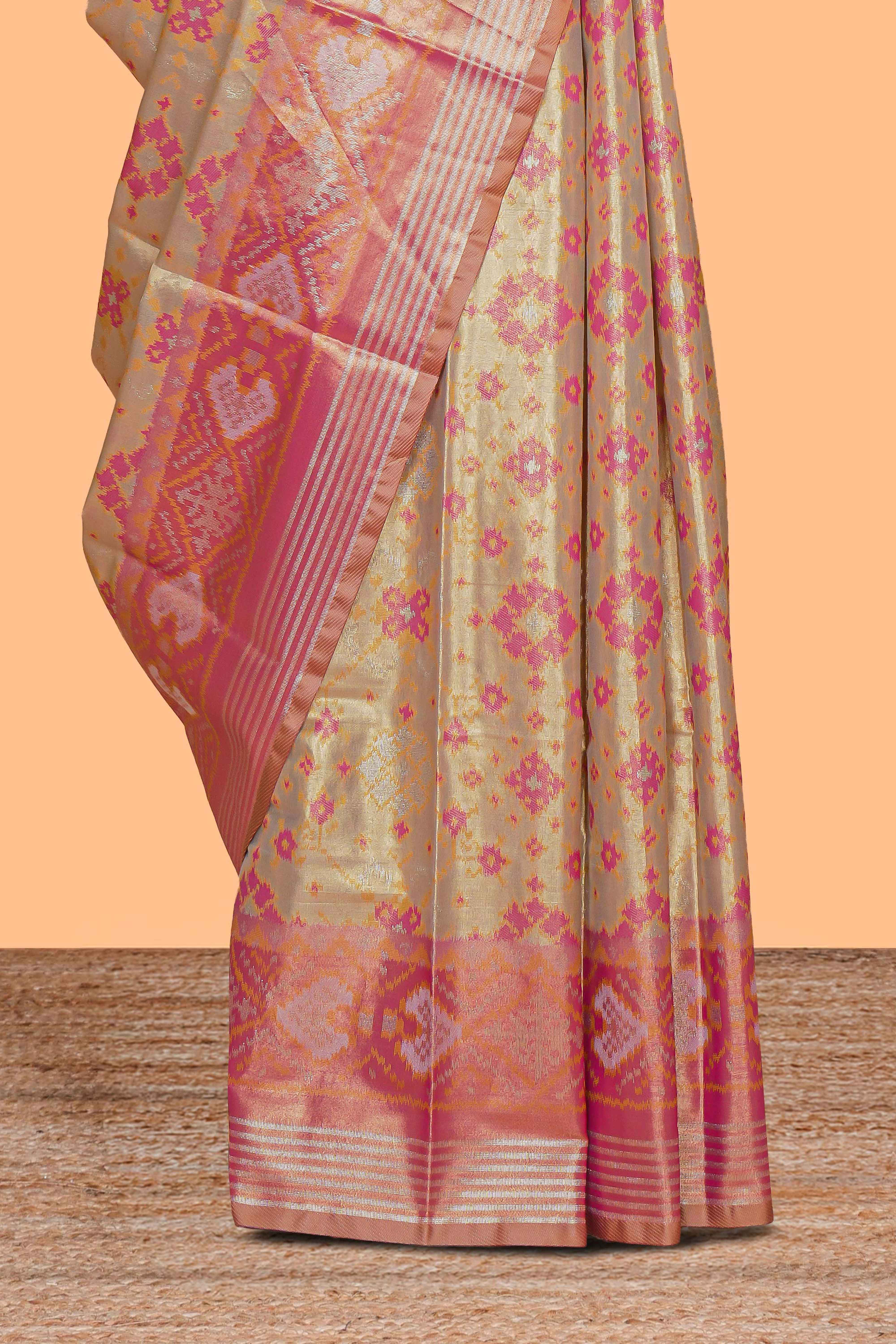 Gold floral design tissue saree with contrast zari border and motifs blouse