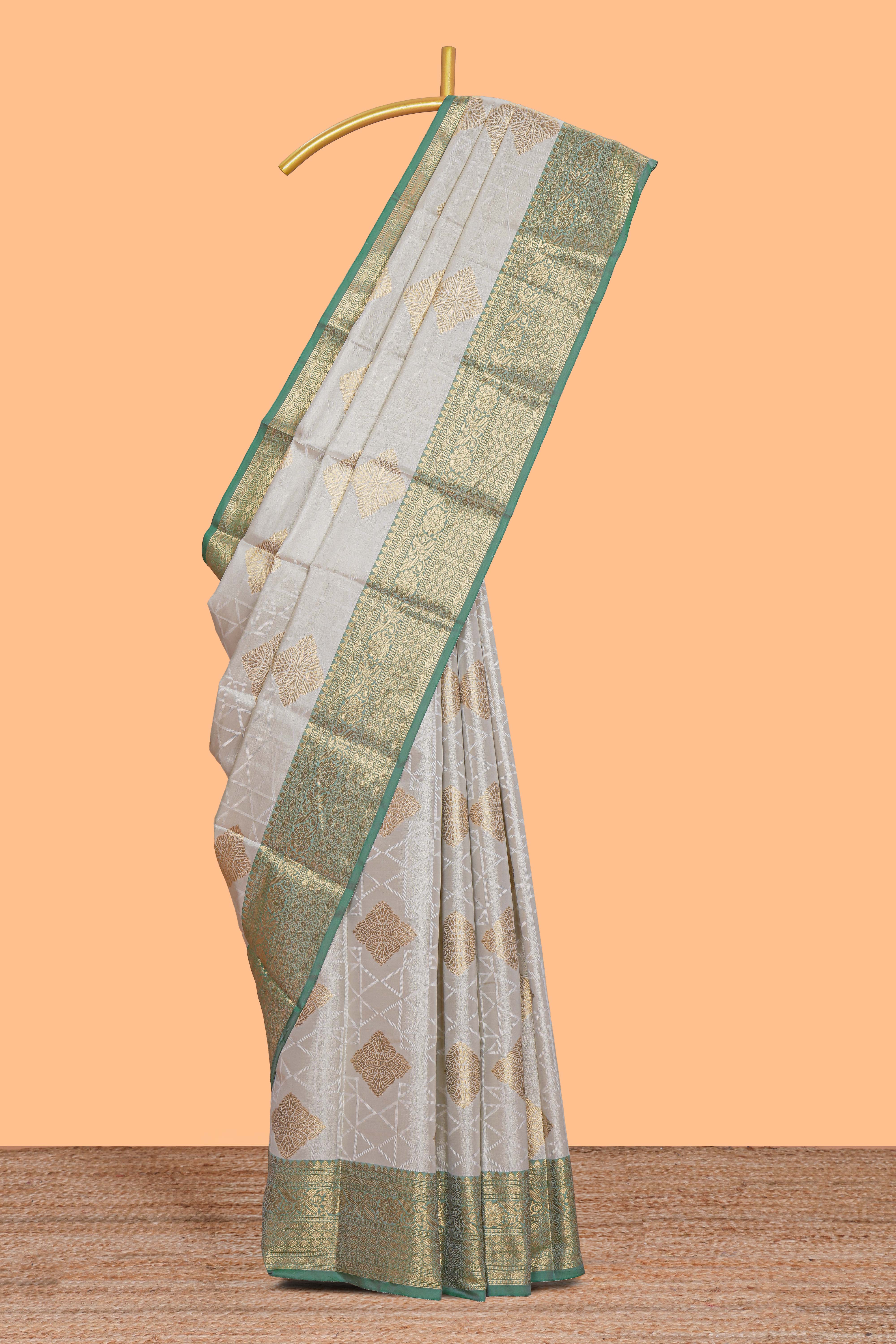 Grey zari motifs design tissue saree with contrast zari border and zari blouse