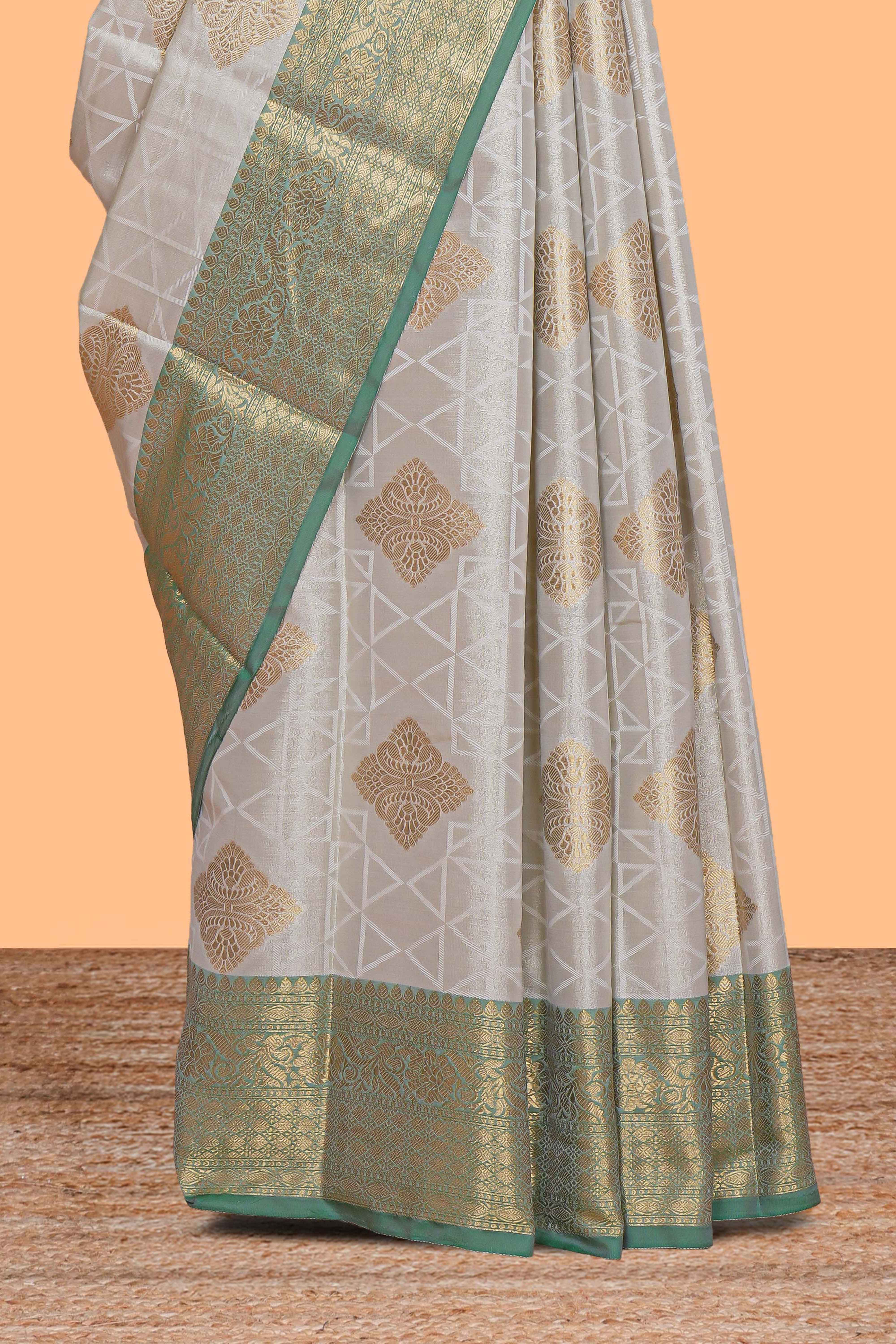 Grey zari motifs design tissue saree with contrast zari border and zari blouse