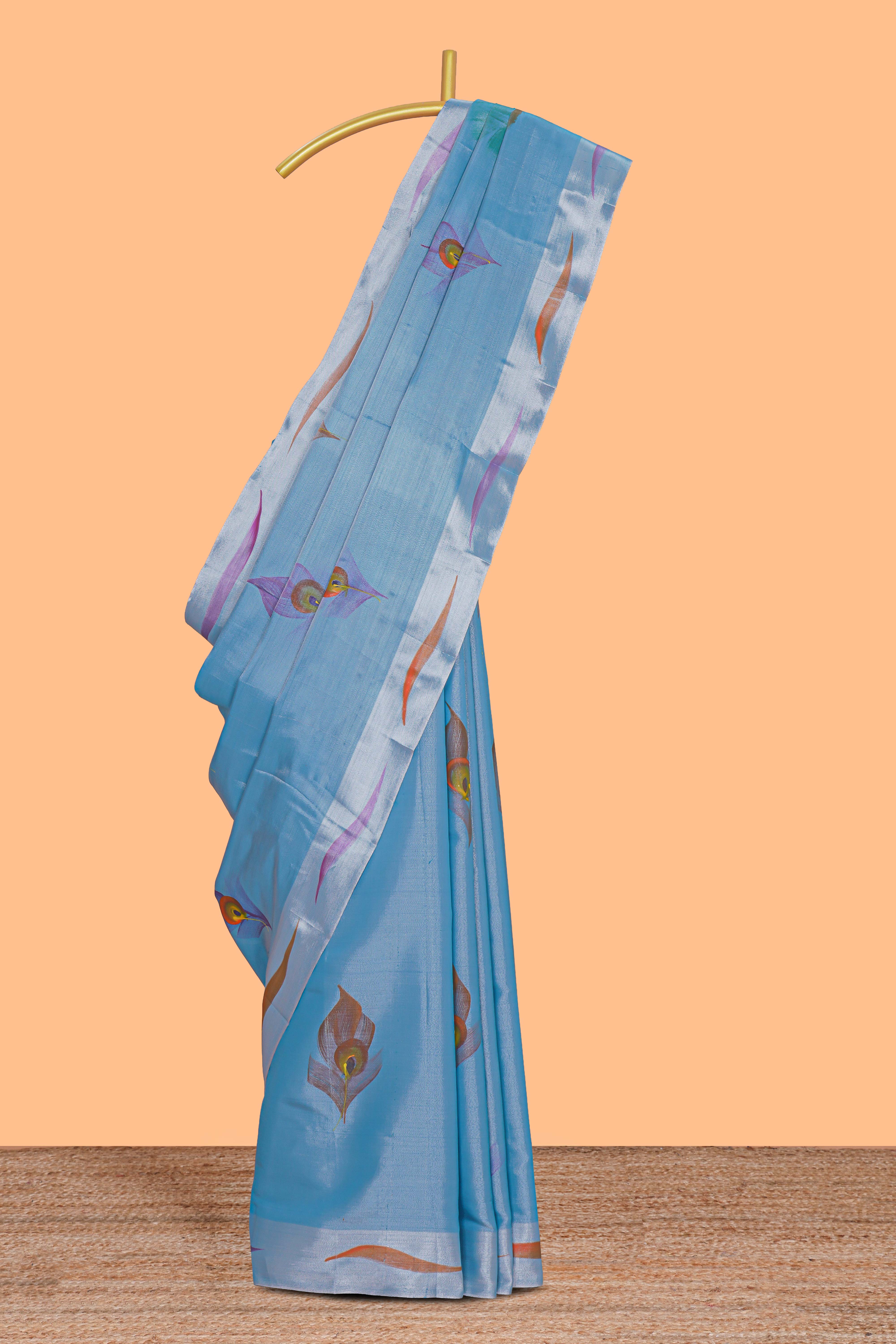 Blue peacock feather design tissue saree with self zari border and contrast blouse