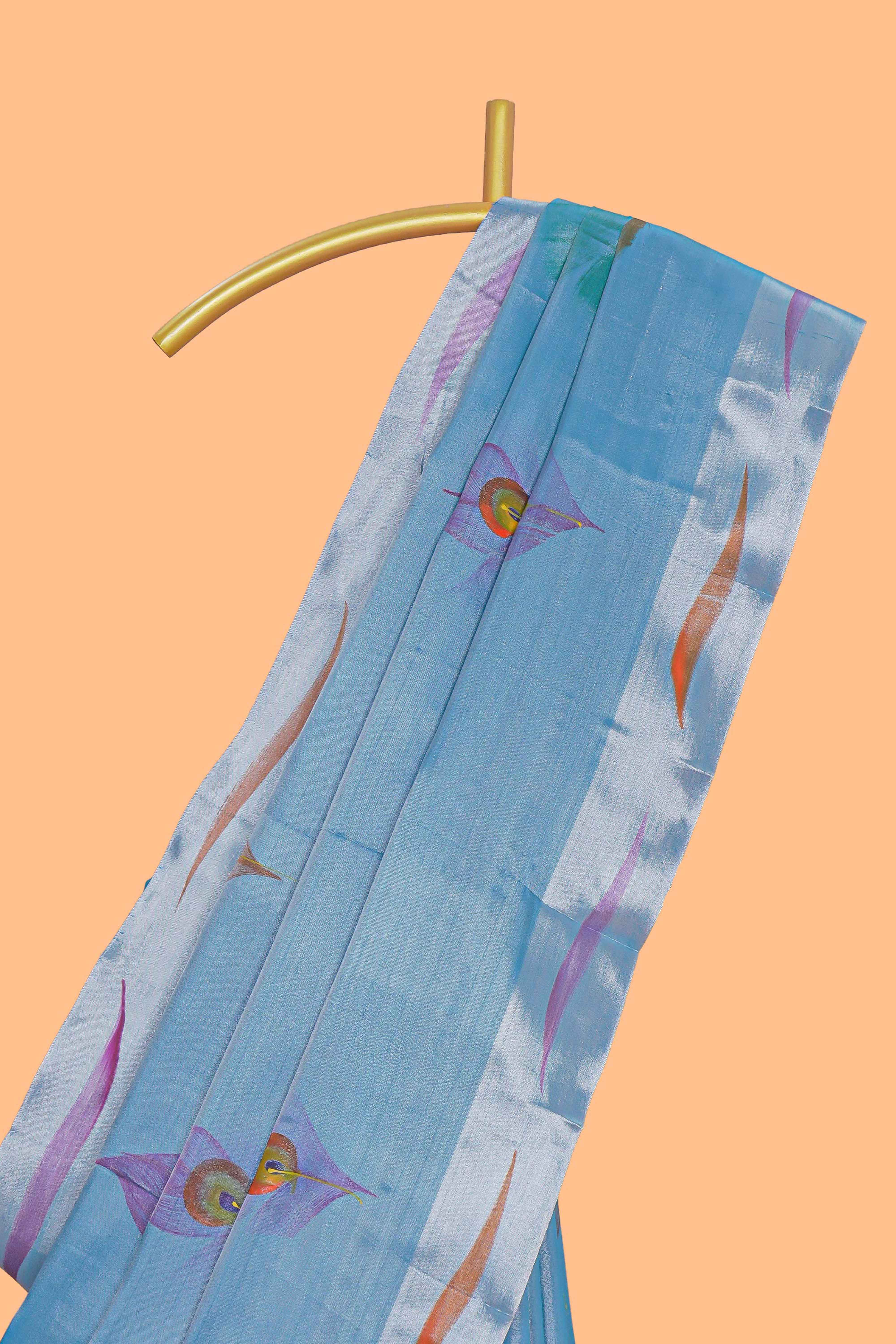 Blue peacock feather design tissue saree with self zari border and contrast blouse