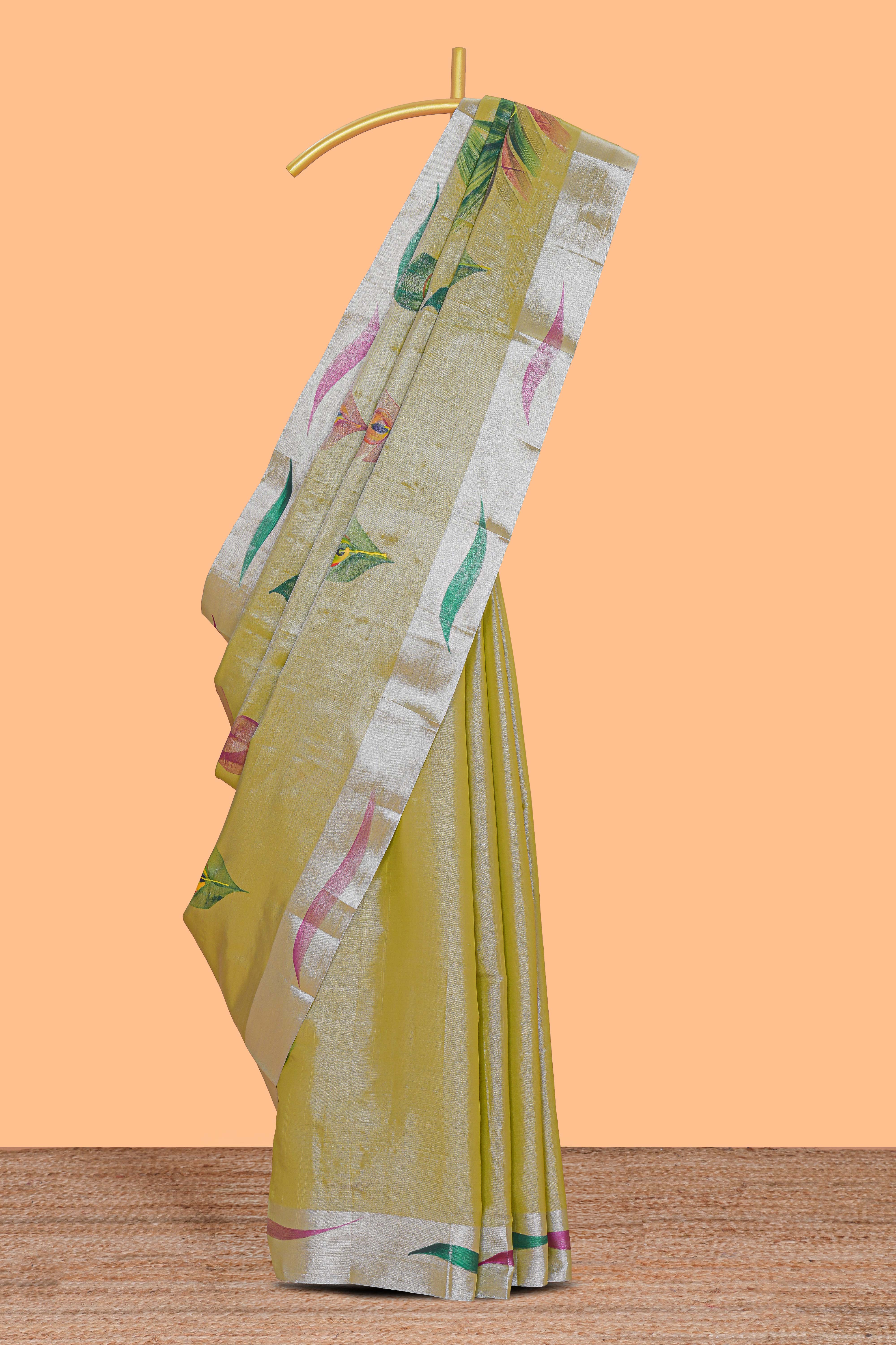 Green peacock feather design tissue saree with self zari border and contrast blouse