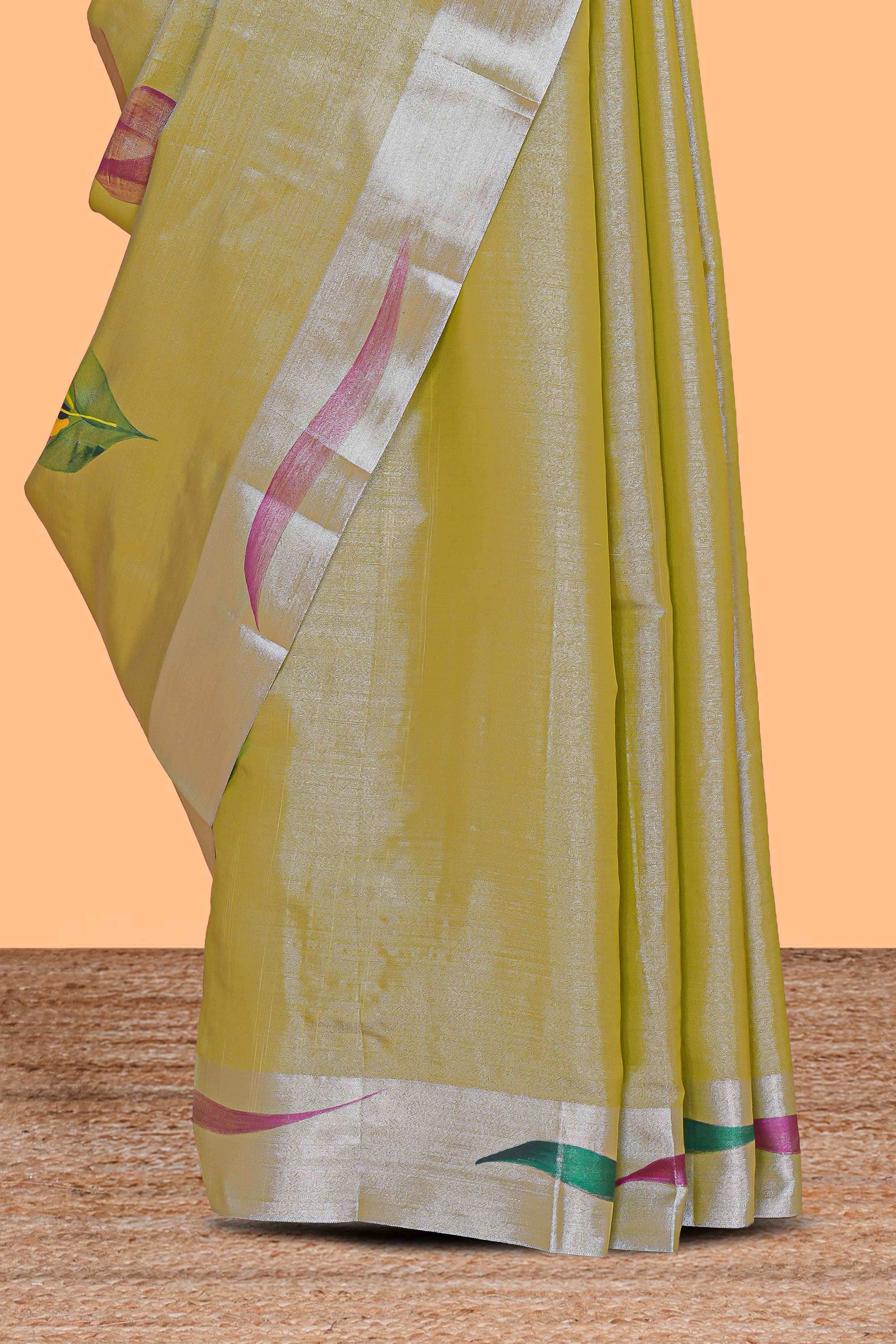 Green peacock feather design tissue saree with self zari border and contrast blouse