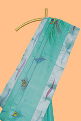 Teal green peacock feather design tissue saree with self zari border and contrast blouse
