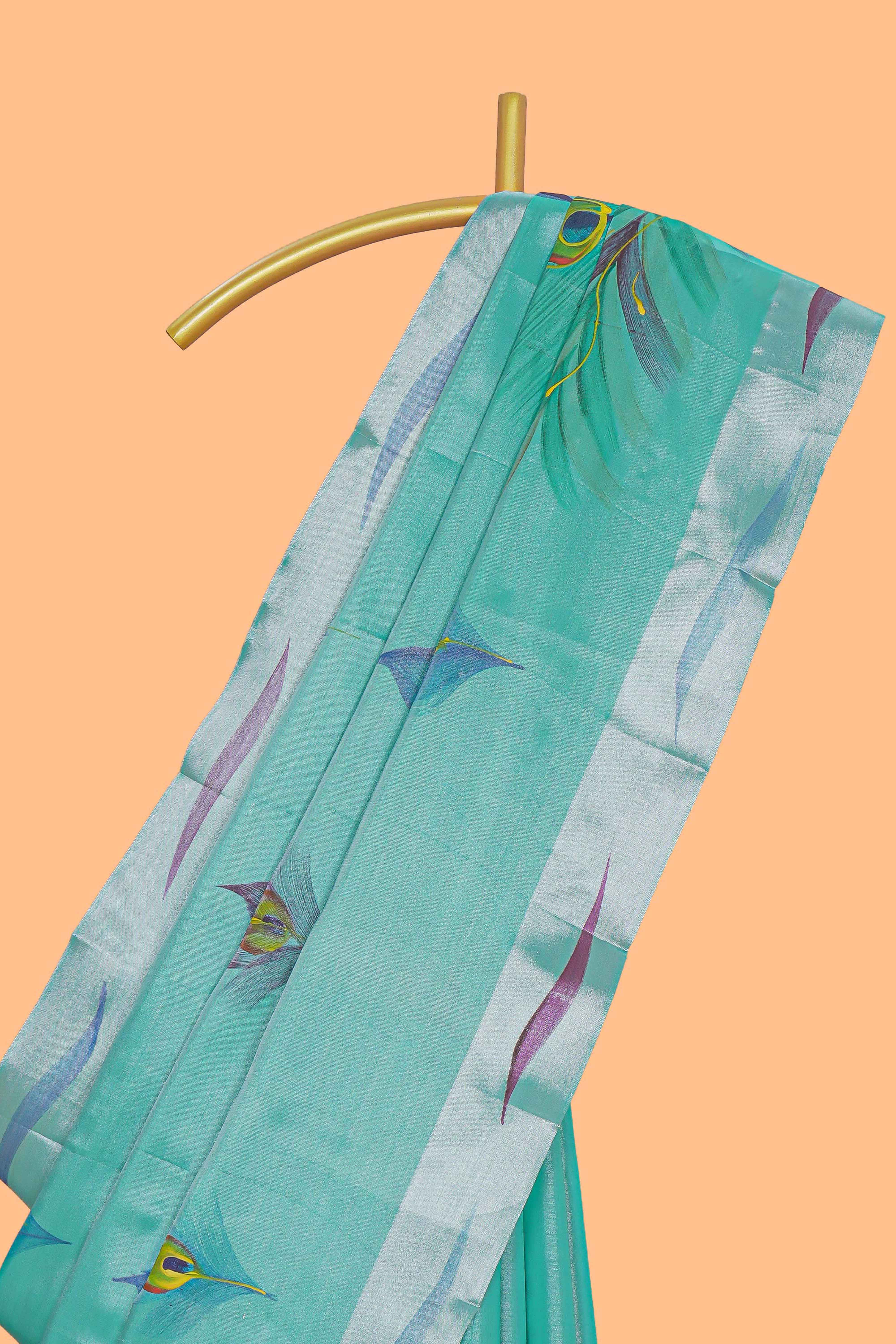 Teal green peacock feather design tissue saree with self zari border and contrast blouse