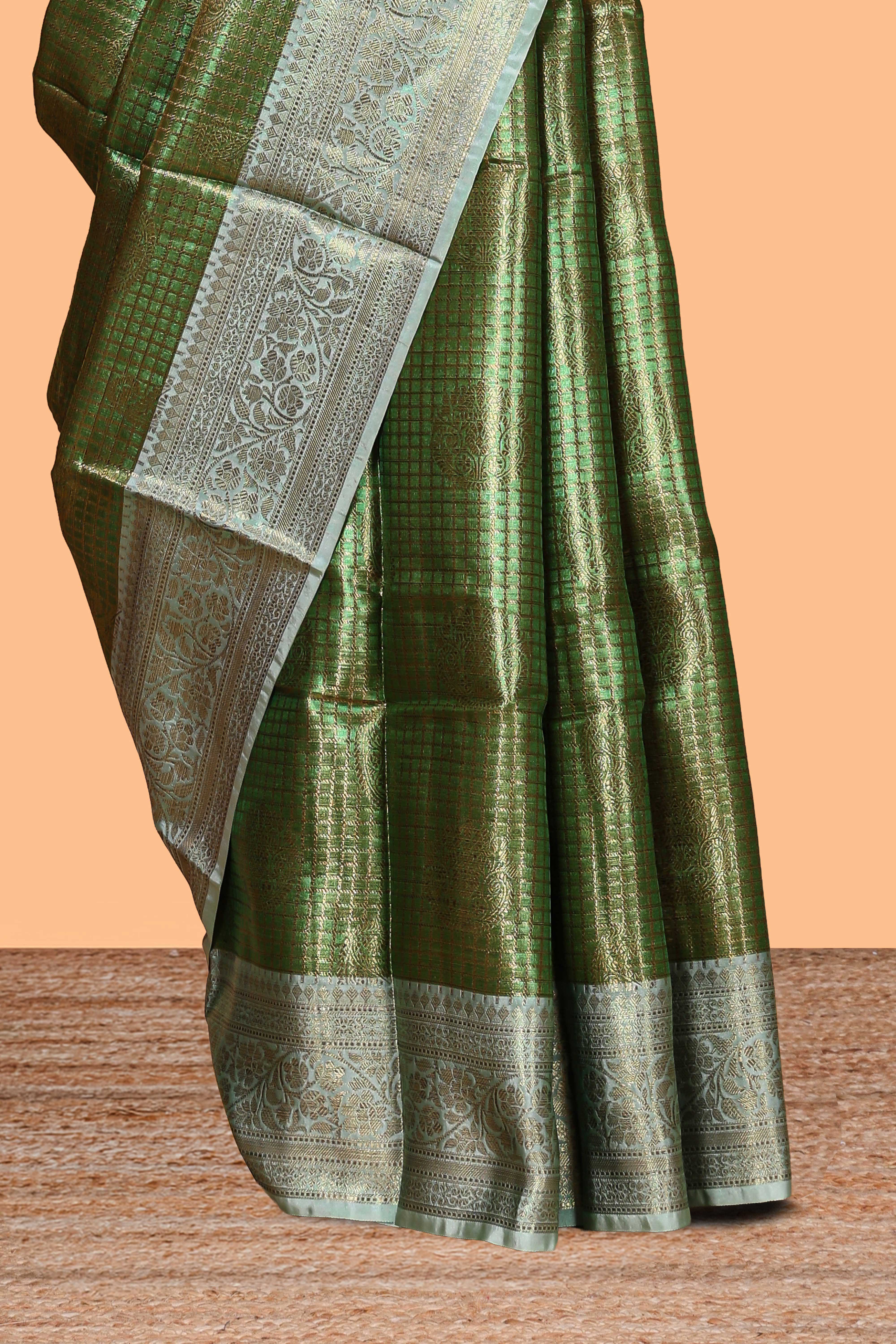 Green checked zari motifs design art tissue saree with self zari border and contrast motifs blouse