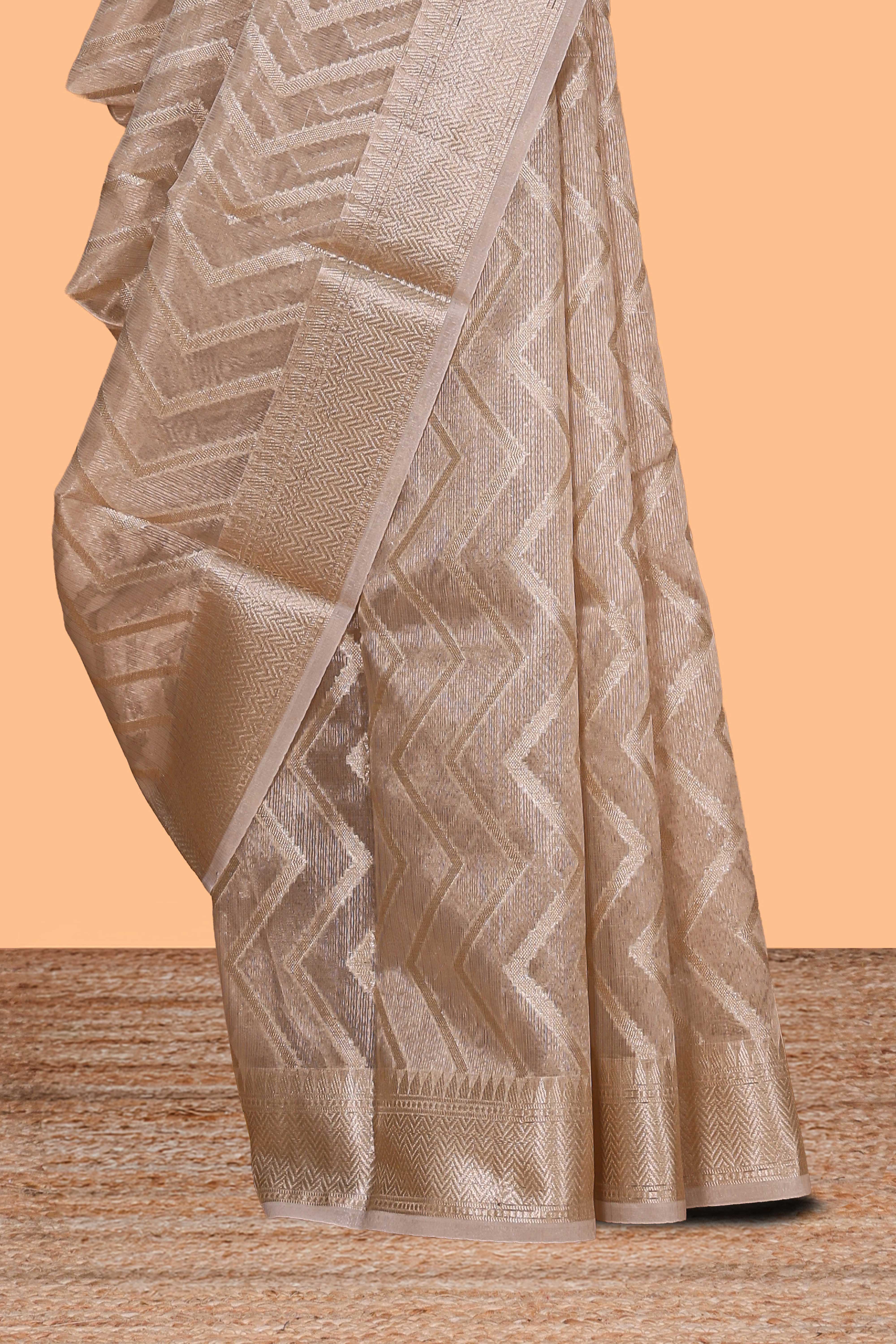 Beige chevron design art tissue saree with self zari border and matching printed blouse