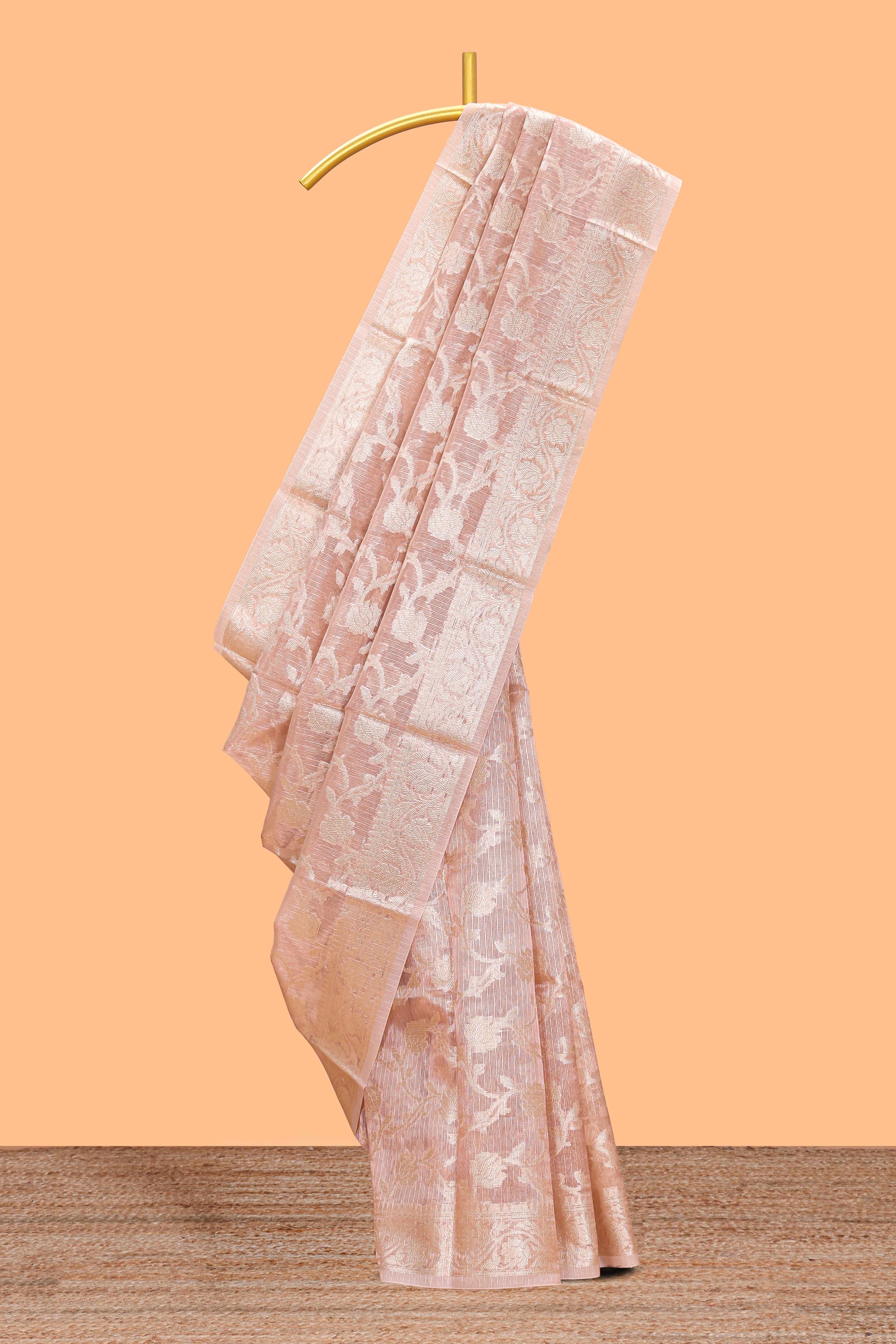Warm peach floral vine design art tissue saree with zari work border and blouse
