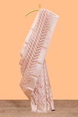 Peach color geometric design art tissue saree with contrast zari border and matching blouse