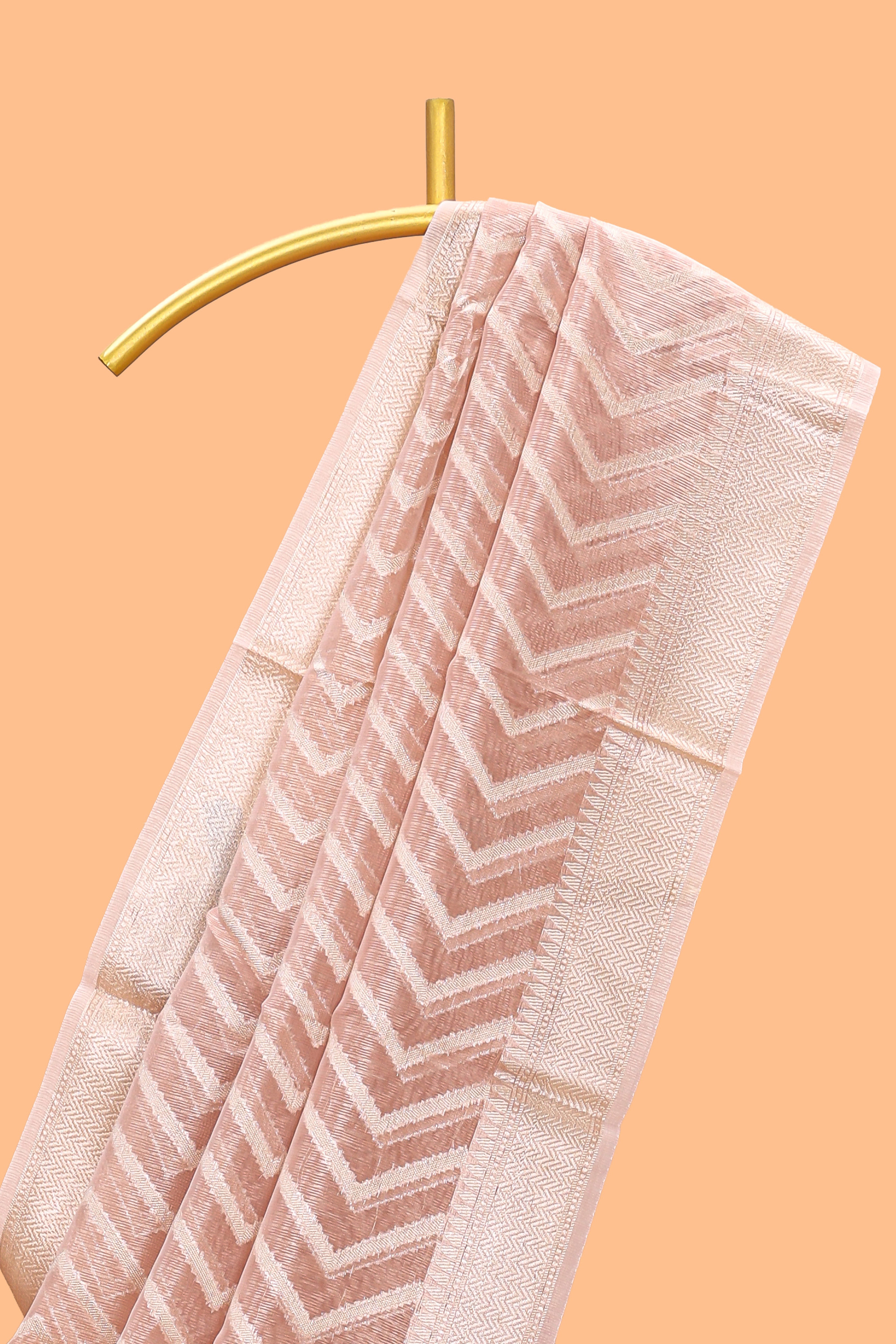 Peach color geometric design art tissue saree with contrast zari border and matching blouse
