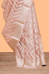 Peach color geometric design art tissue saree with contrast zari border and matching blouse