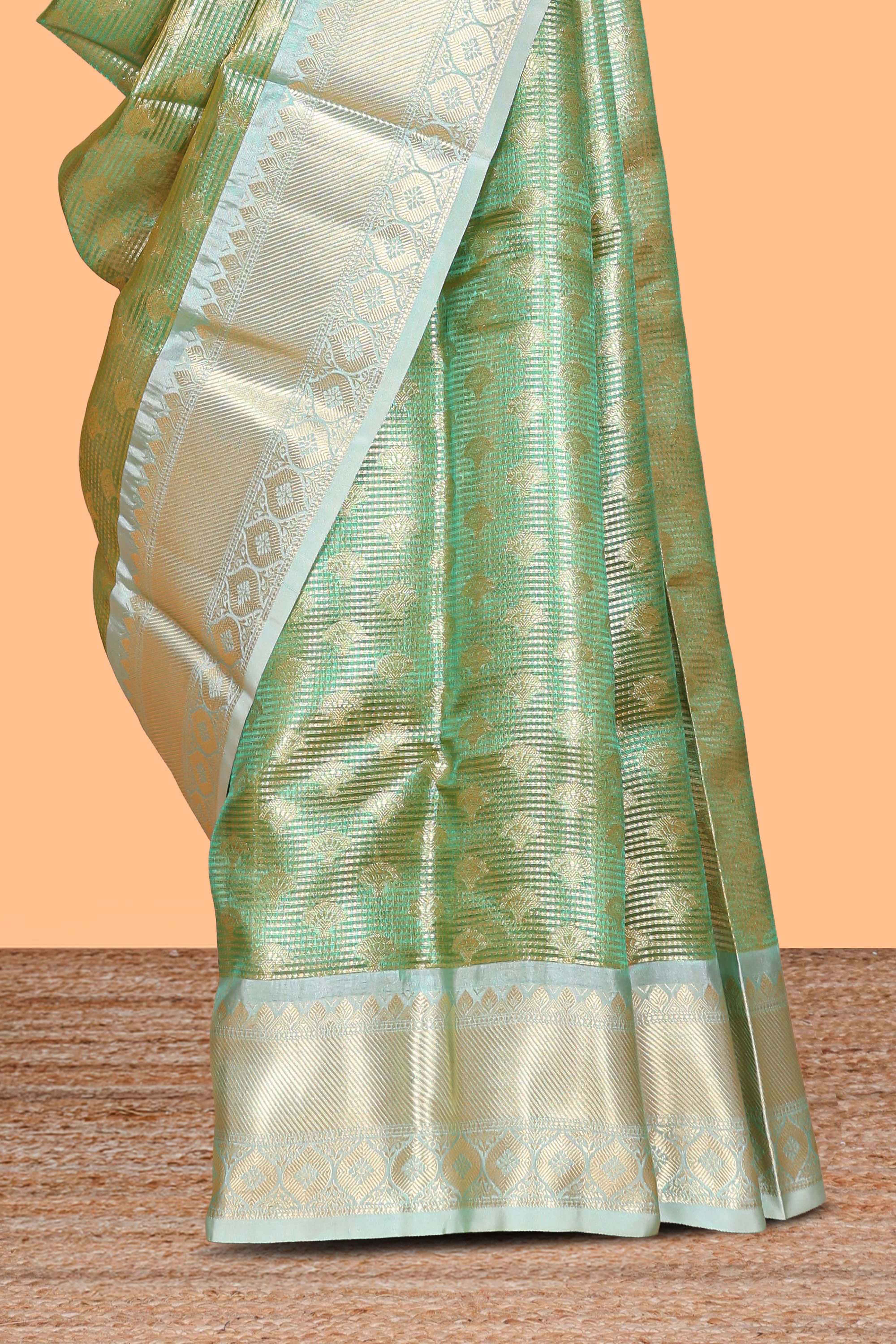 Green zari motifs design art tissue saree with contrast zari border and motifs blouse