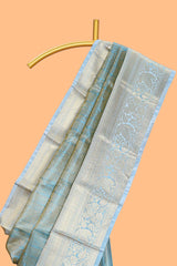 Blue zari design art tissue saree with self zari border and contrast blouse