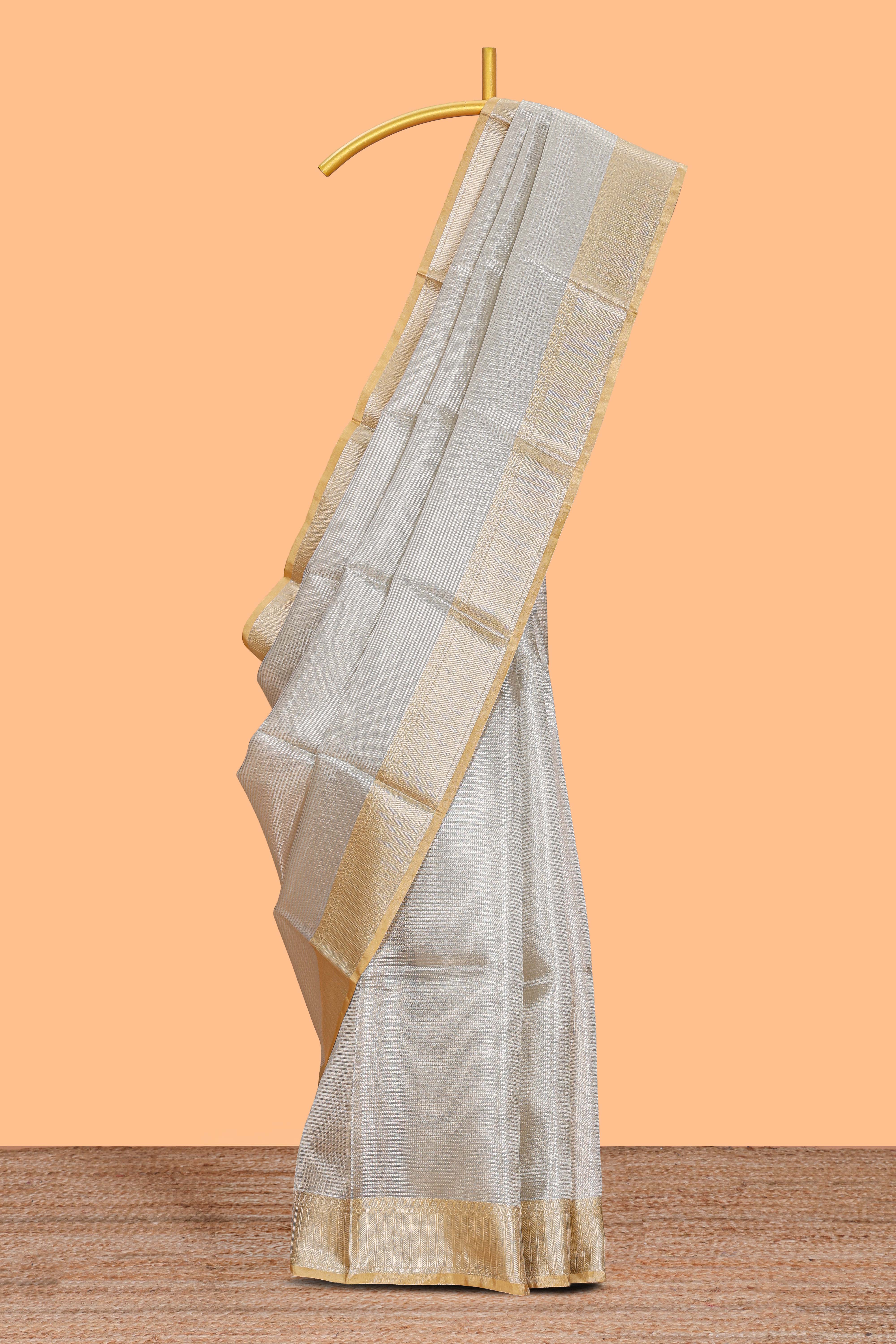 Grey zari design art tissue saree with contrast border and zari design blouse