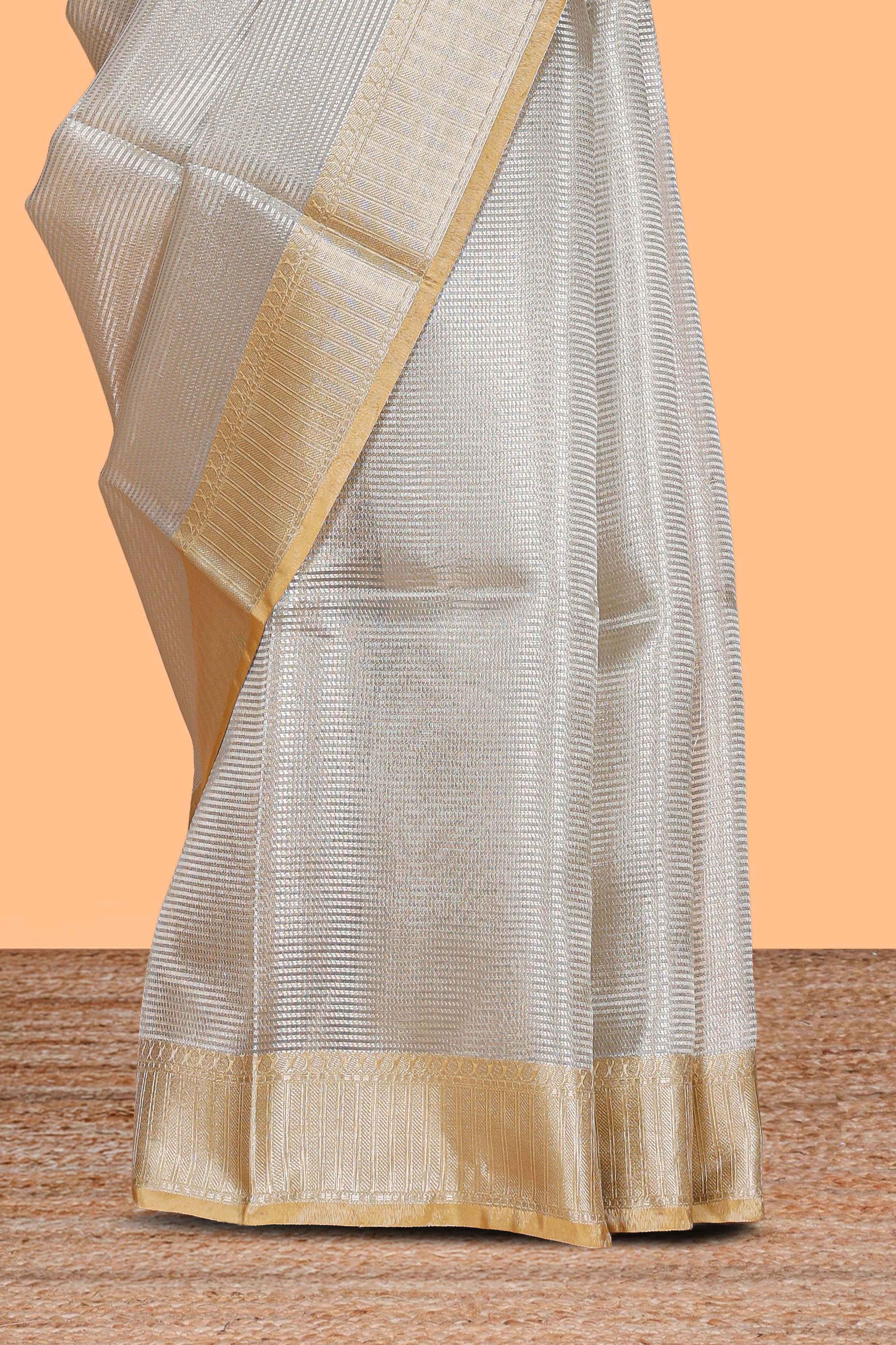 Grey zari design art tissue saree with contrast border and zari design blouse