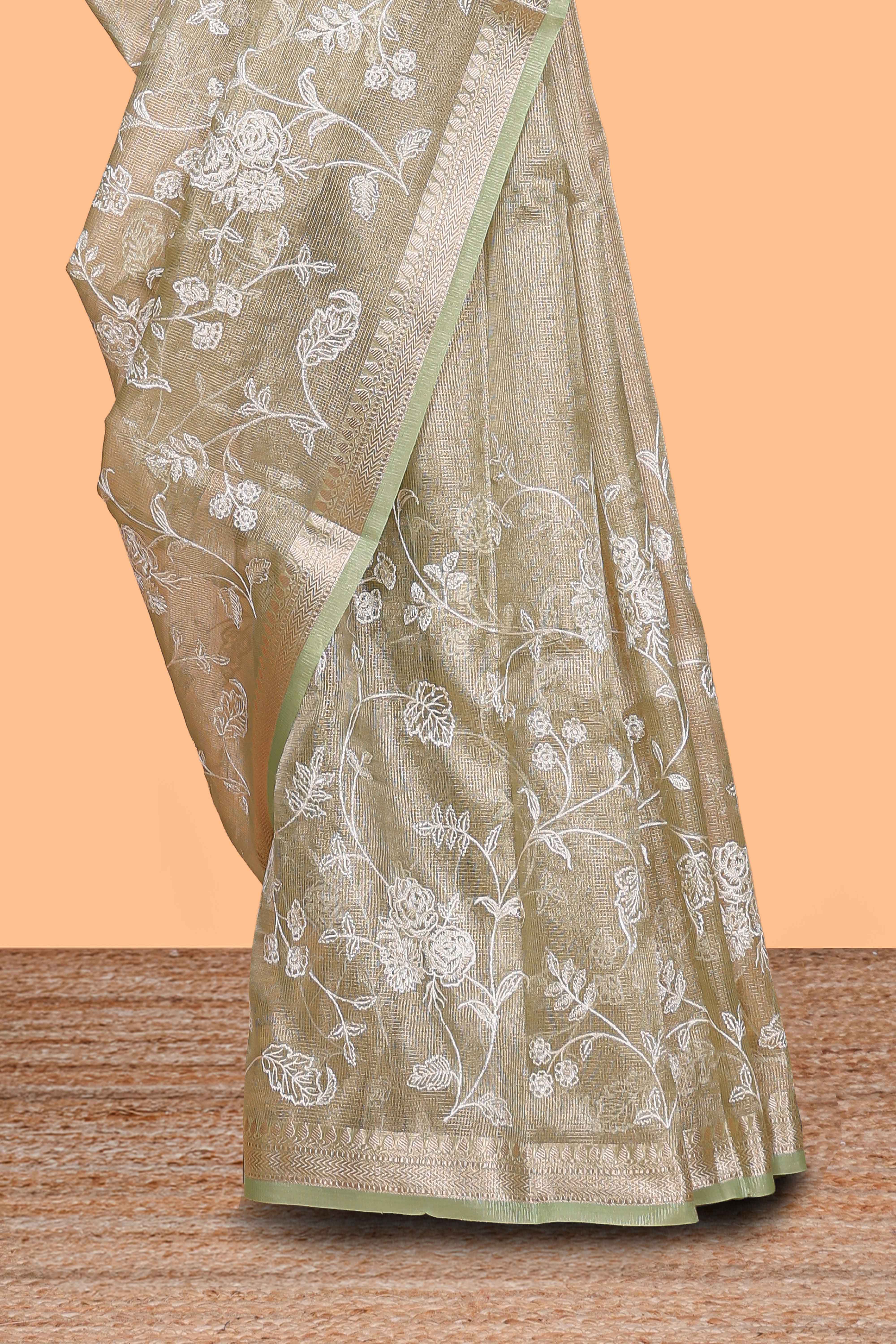 Pale green floral design art tissue saree with self zari border and plain blouse