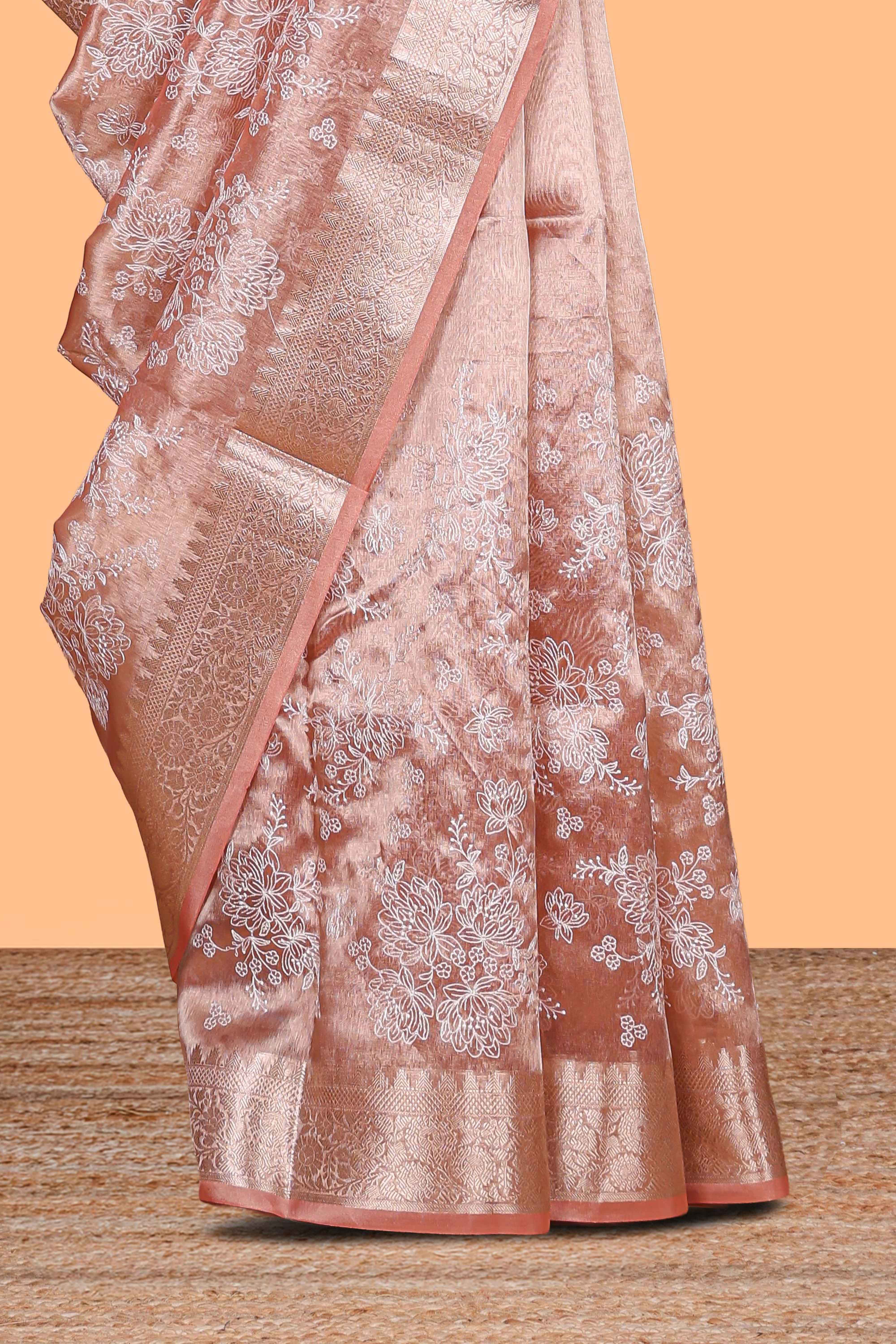 Peach floral design art tissue saree with self zari border and Matching blouse along with the floral designed pallu