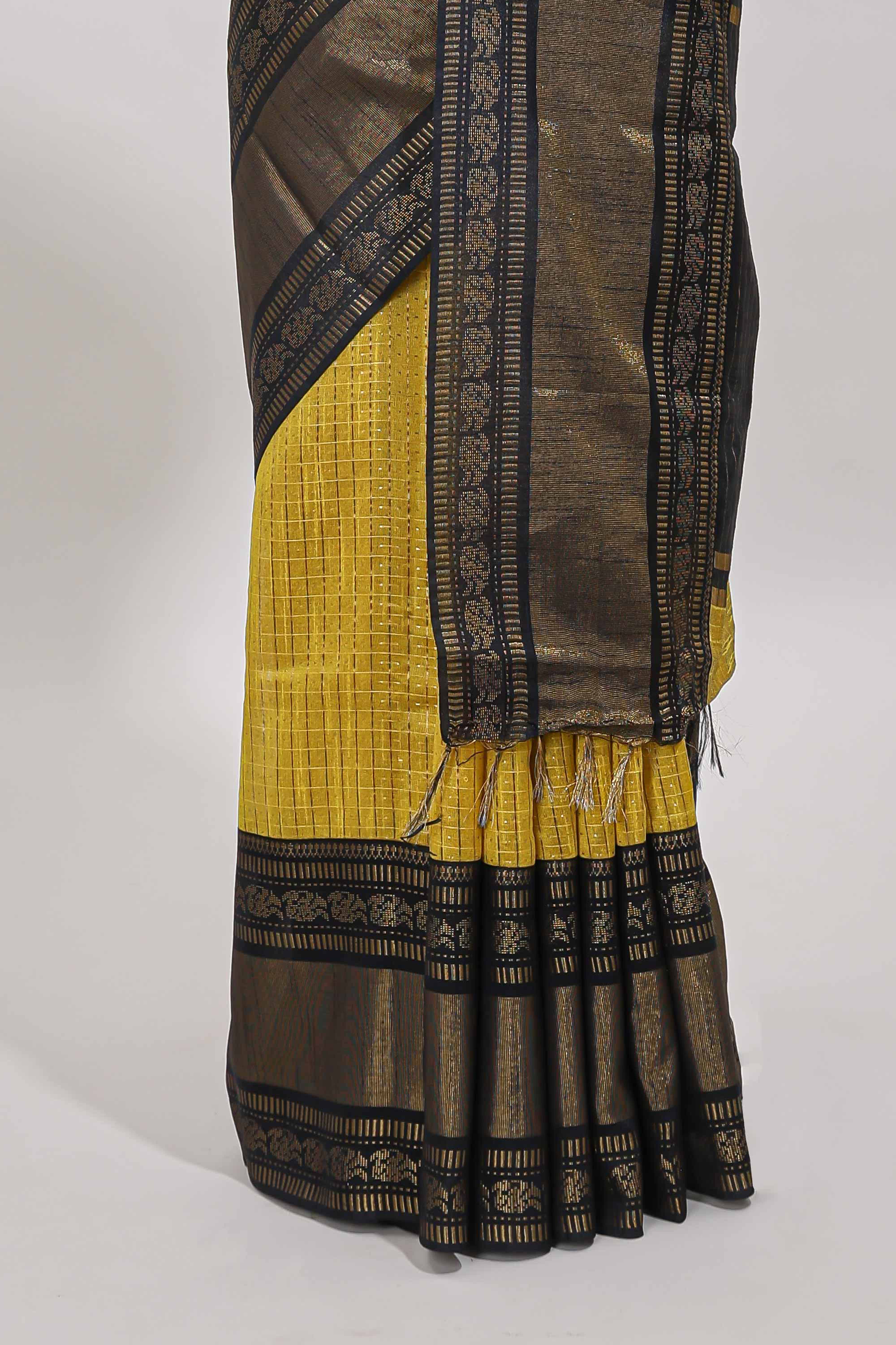 Yellow checked tussar saree with contrast black zari border and checked blouse